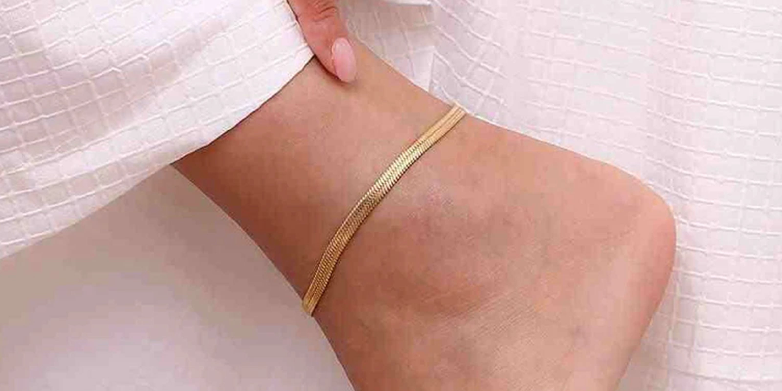 Close-up of ankle wearing gold and rhinestone anklets with text Anklets and Let Your Anklets Do The Talking