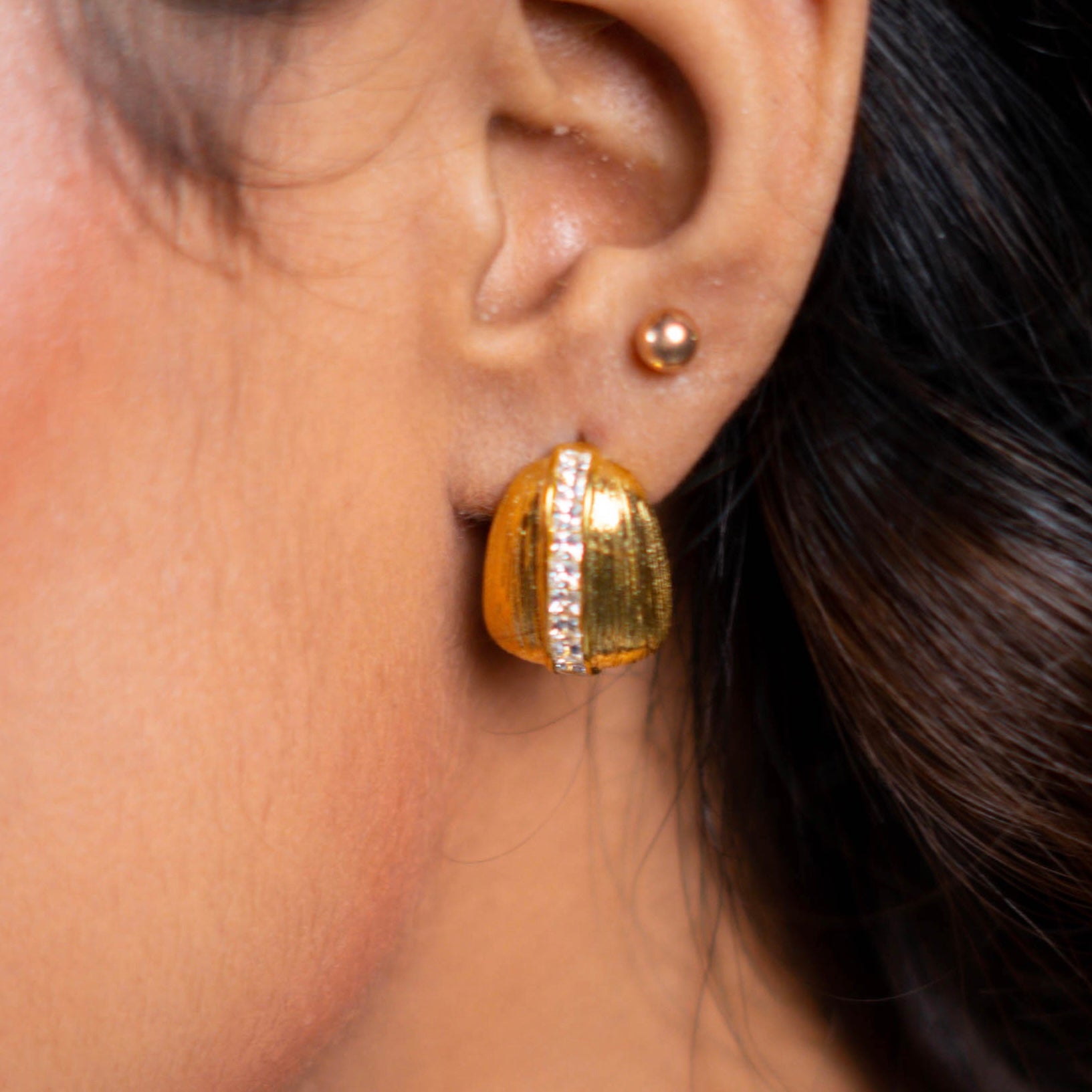 Girl wearing Bosch Studs. Ribbed dome gold plated earrings - Mithra & Co
