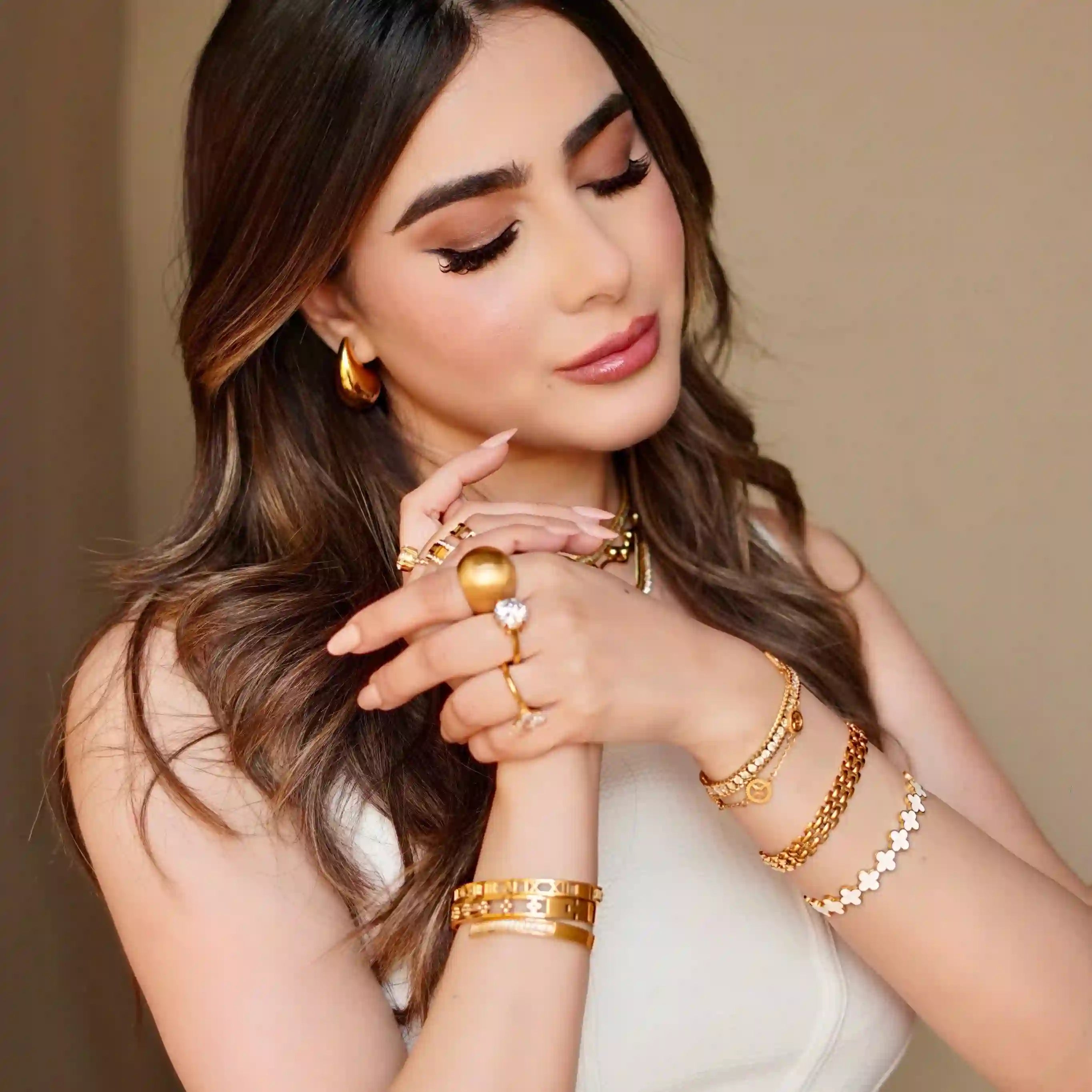 Girl wearing 18k Gold Plated Bracelets in both hands. Buy Now at Mithra and Co.