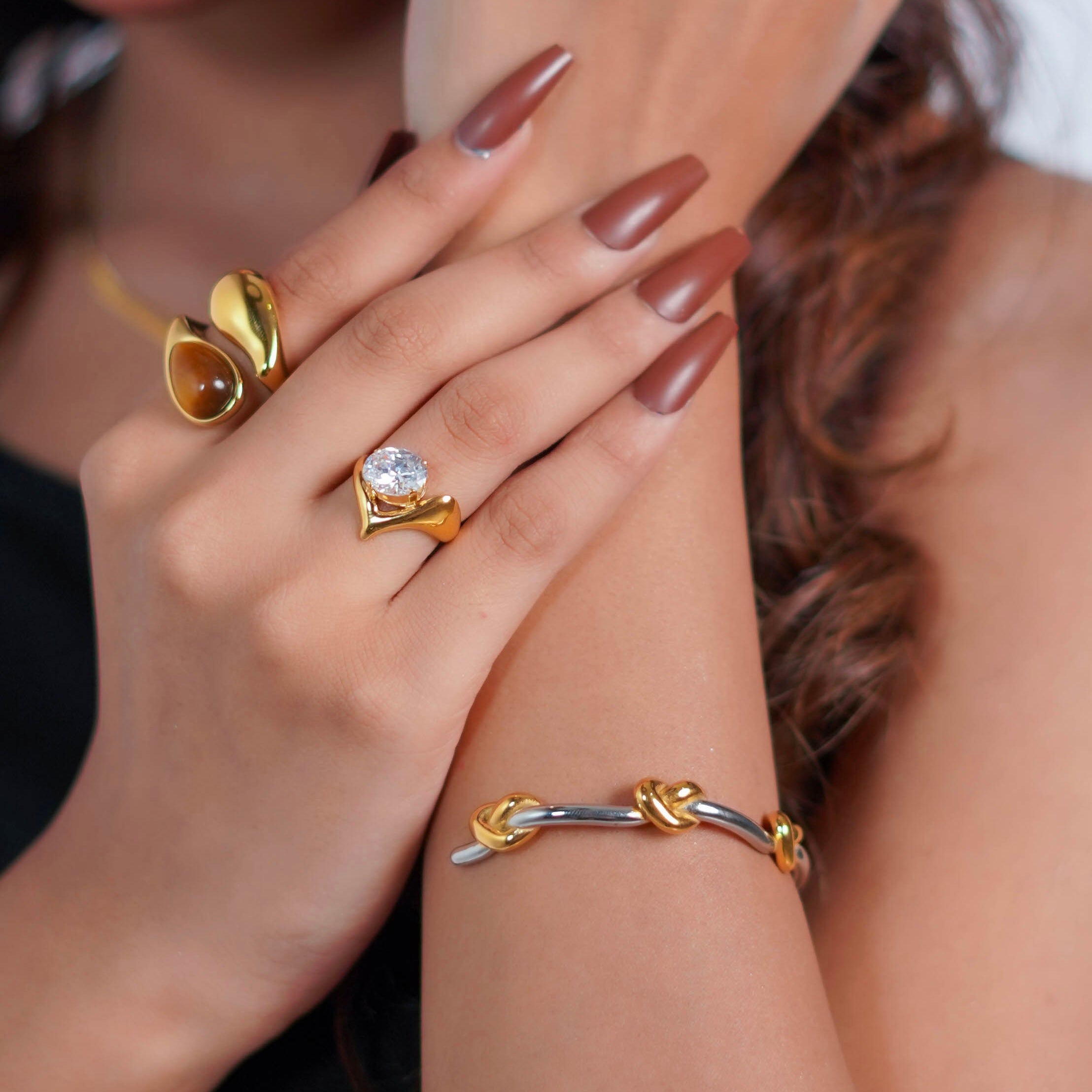 Girl wearing 18k Gold plated Fleur d’Or Ring and Solerium open cuff knot Bracelet Shop at Mithra & Co