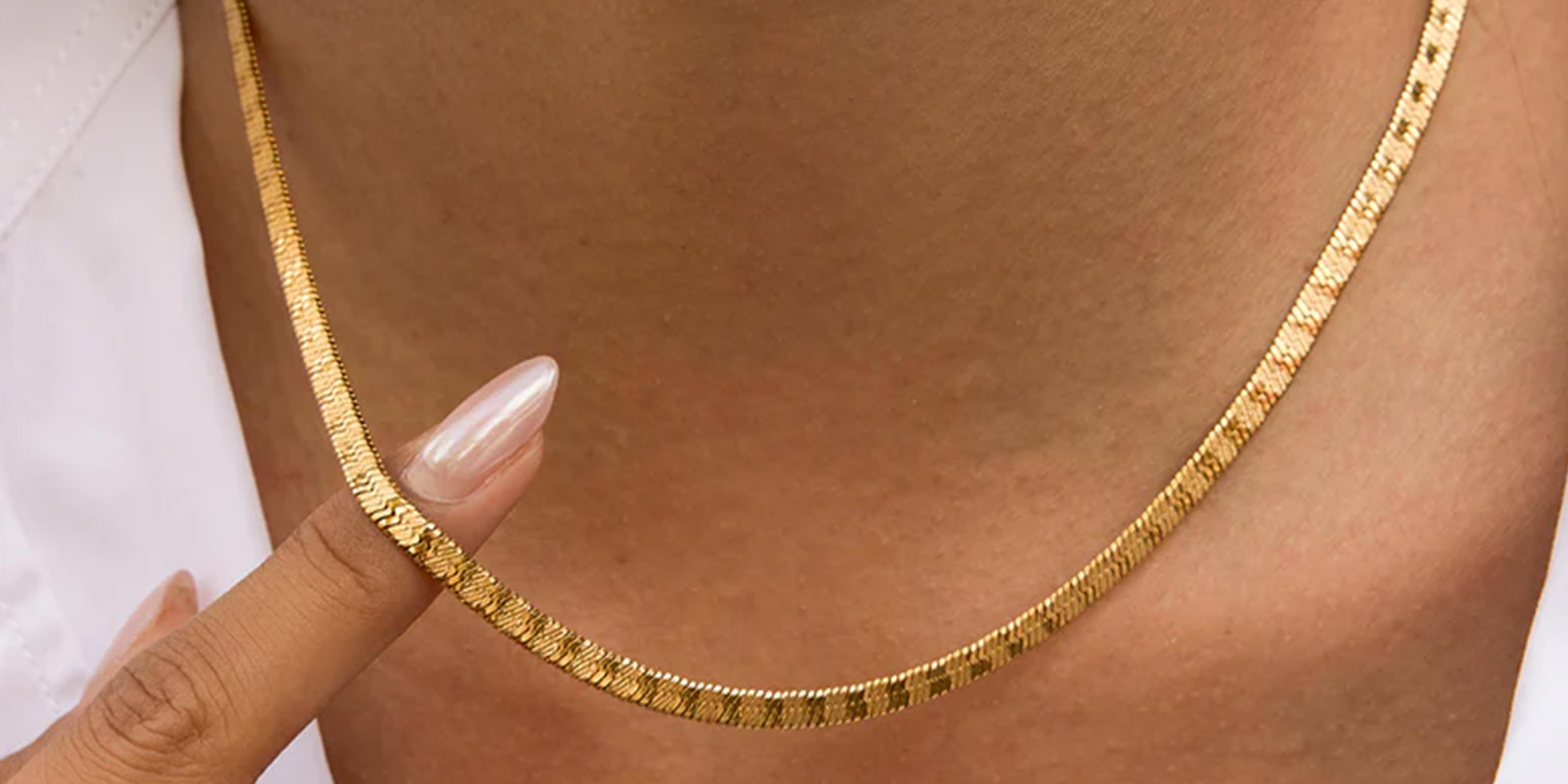 barely Bold Collection - Shwocasing woman's neck wearing Gold Plated Necklace with a blurred background