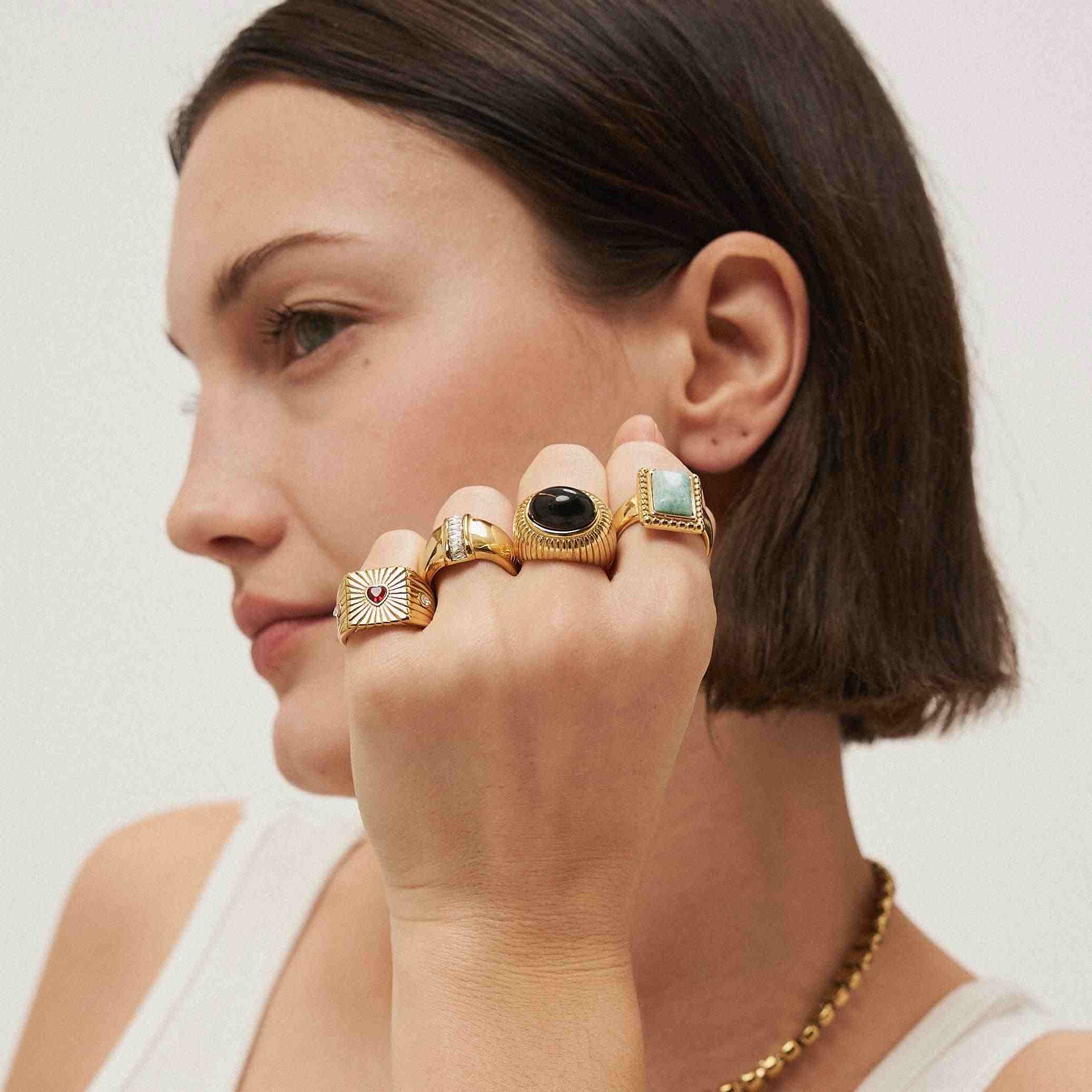 Girl wearing Rings with Stones. 18k Gold Plated. Shop at Mithra and Co.