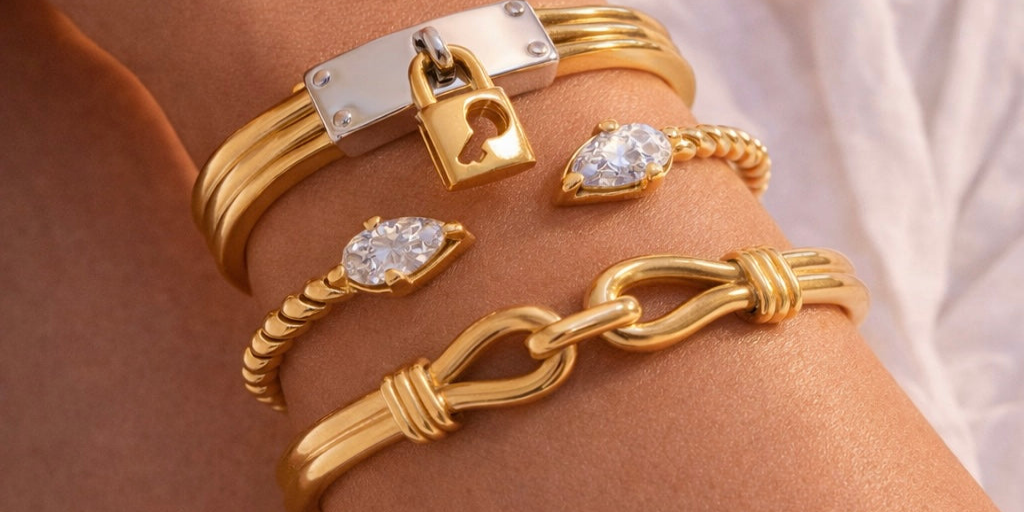 Closeup of a girl's right hand wearing Barely Bold 18k Gold plated bangles with lock and chain designs