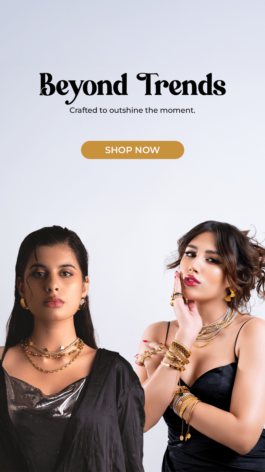 Two women wearing gold jewelry with 'Beyond Trends' text and 'Shop Now' button on a light gray background.