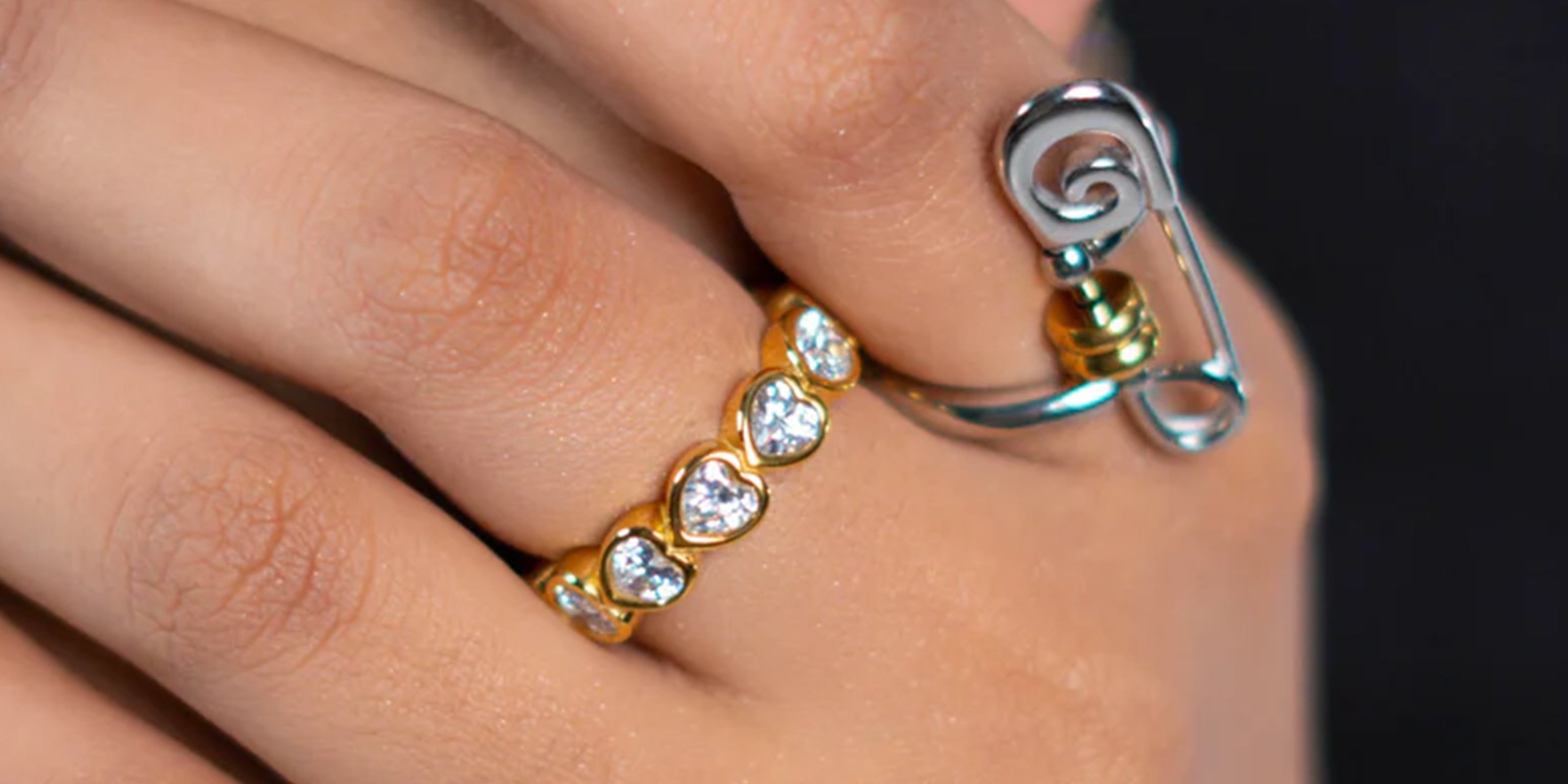 Party Ready Collection Featuring Close-up of a girl's hand wearing two rings (safty ring and leute band) with decorative elements.