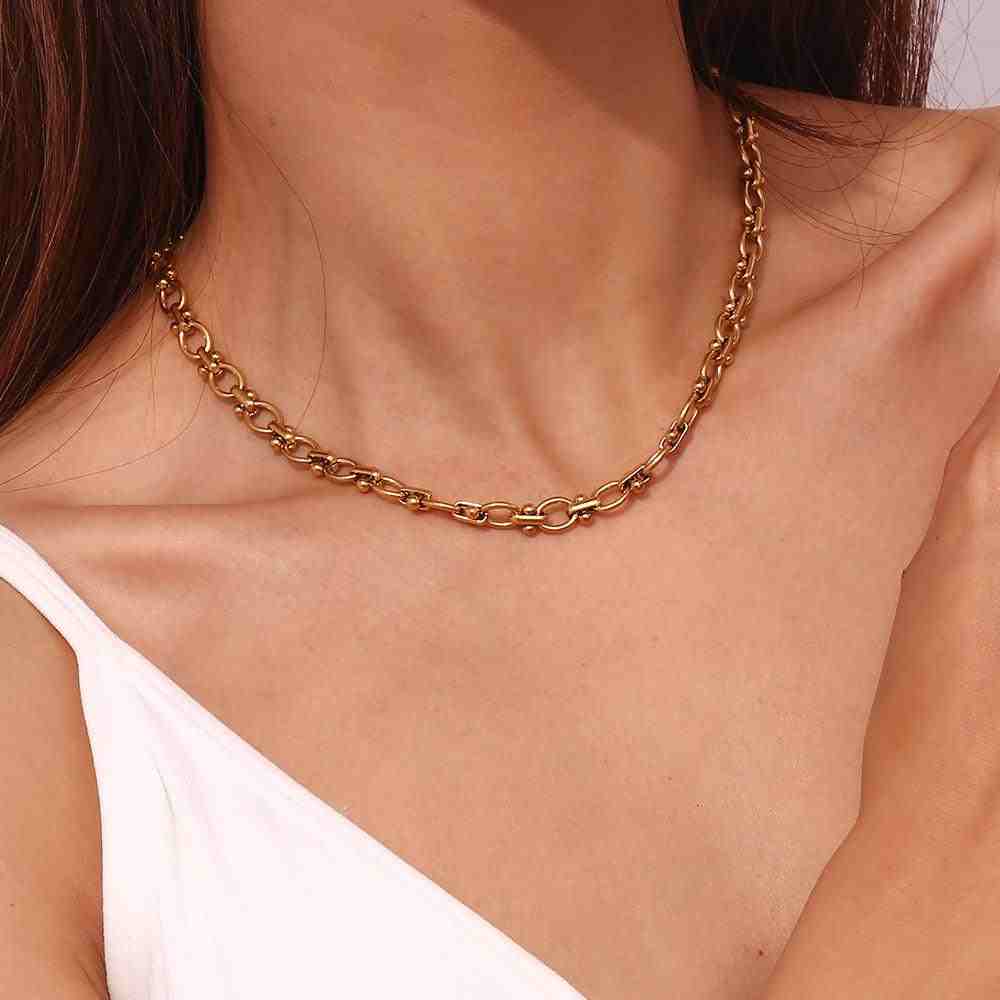 Closeup of Girl wearing Delulu Chain Necklace. A Beaded Station Oval Link Chain made with 18k Gold plated steel.