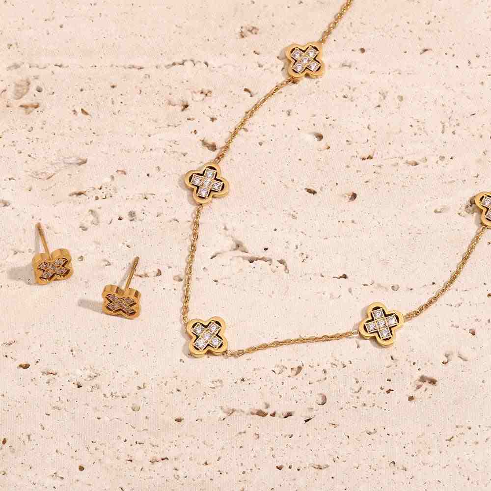 Display of 18k Gold Plated GIlded Clover studs and Gilded clover necklace with 5-Motif Zircon-Inlaid Clover Architecture.