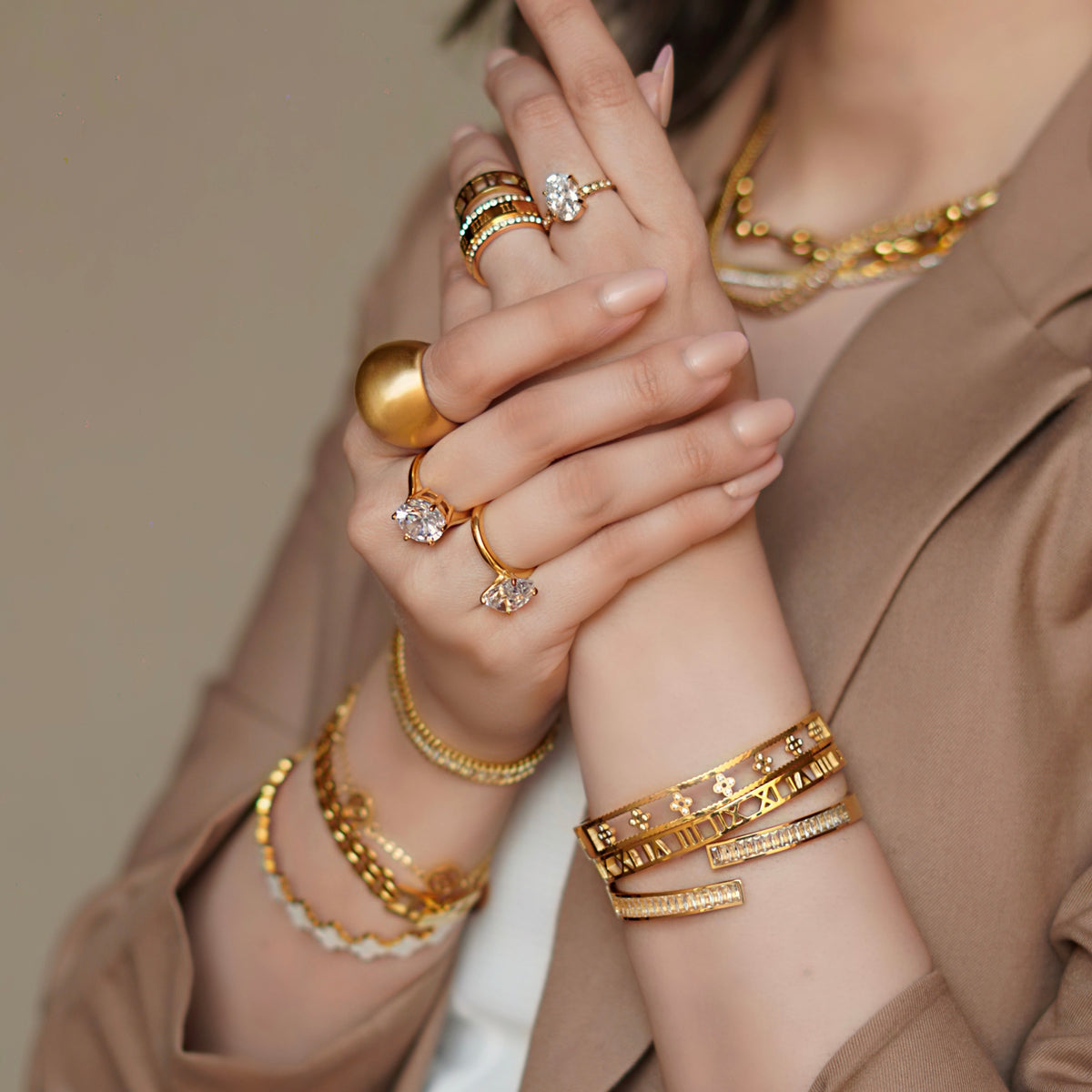 Girl wearing Mithra and Co's 18k Gold plated Jewelry Stack including sculptural dome design Dune Ring.