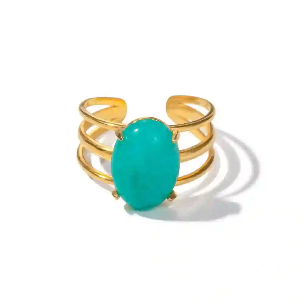 Studio Shot of Oceanic Opal ring. 18k gold plated triple row station band ring with oval shaped turquoise opal.