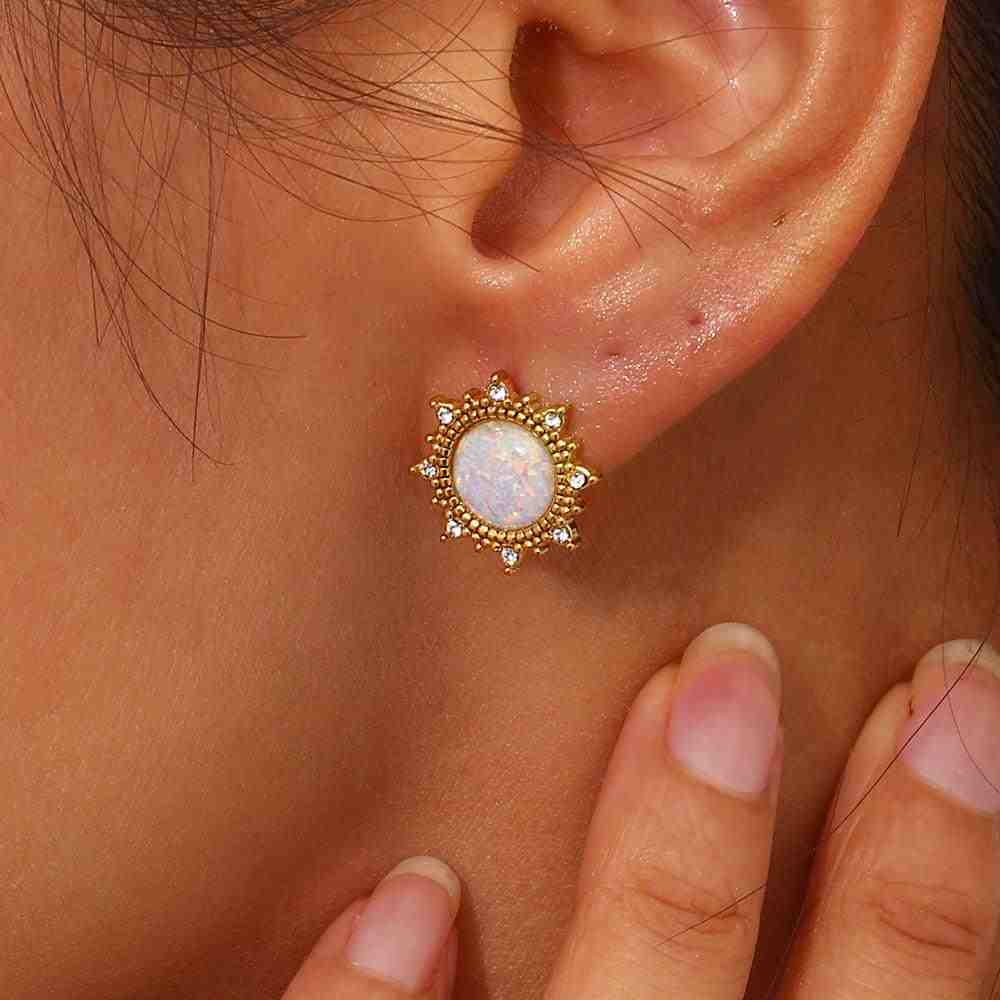 Closeup of a Girl's left ear wearing 18k gold plated Opal Stud earrings featuring a Sun-Inspired Halo over Opal Centerpiece.