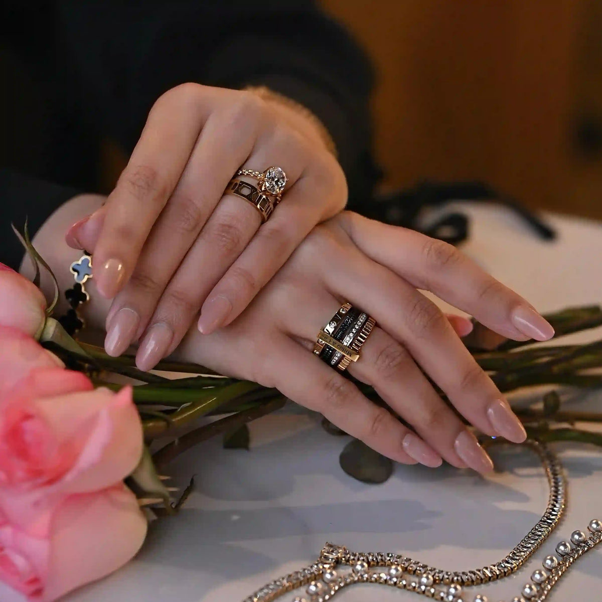 Girl wearing 18k Gold Plated Rings and White pearl Choker Regal emblem necklace placed on textured bg.