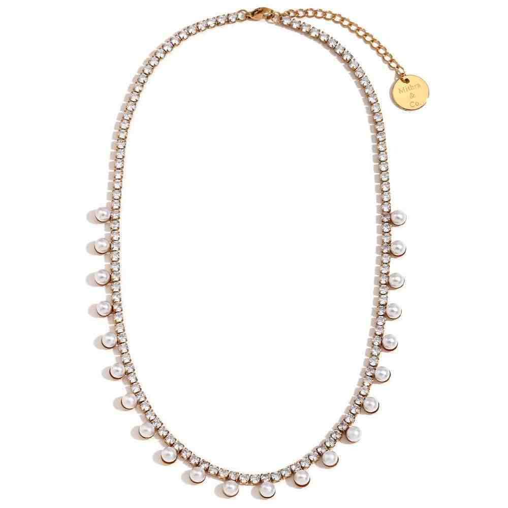 Studio shot of 18k Gold Plated Regal Emblem Necklace adorned with White Pearls with Mithra & Co. Engraved tag.