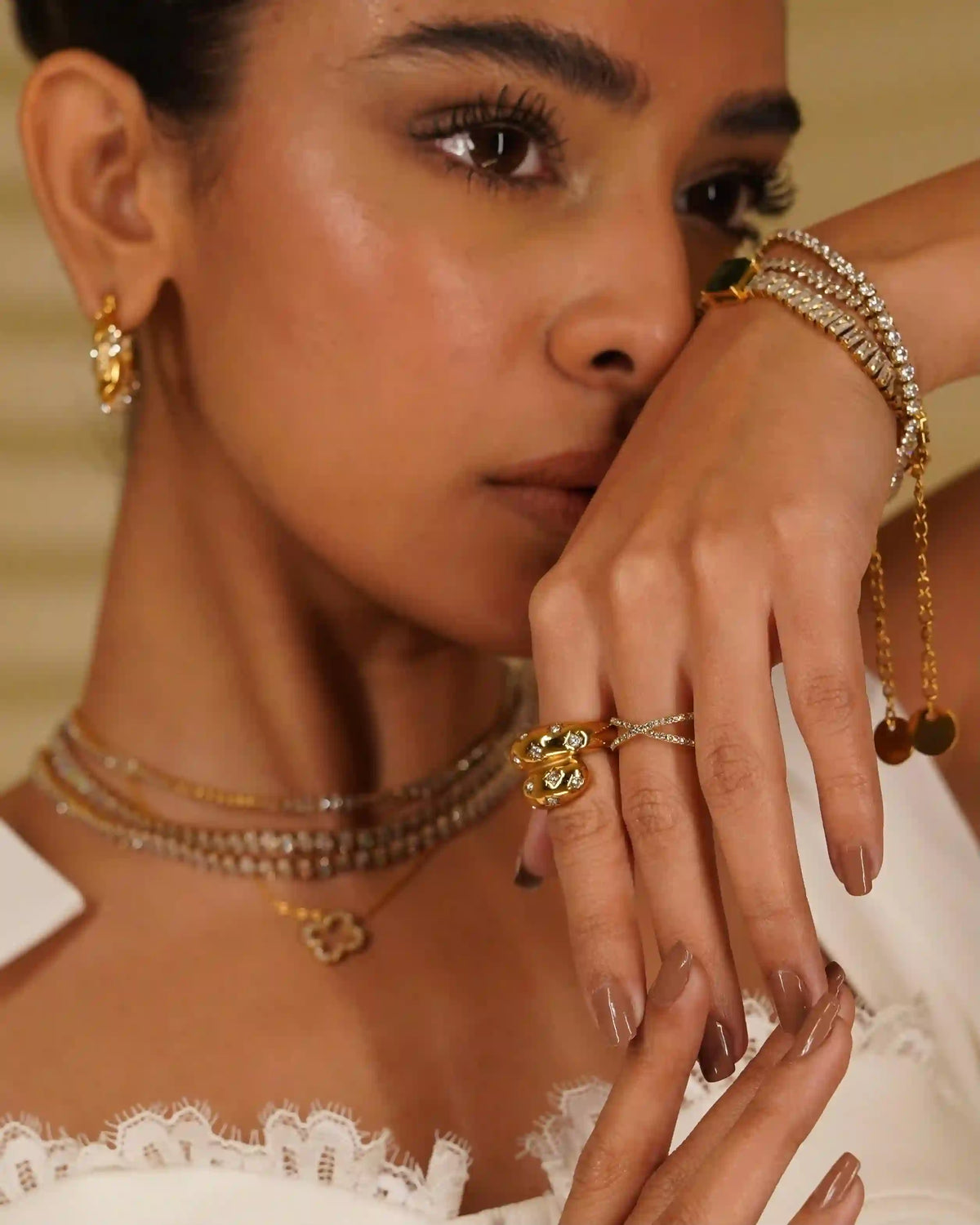 Woman wearing Gold Plated Jewelry Rings Bracelets Earrings and NEcklaces All stacked with COsmic Stars Engraved Wrap around Celestial Ring Band.