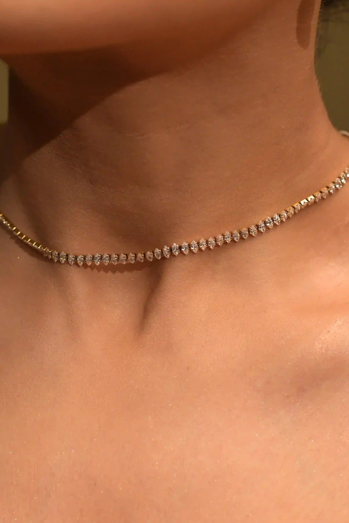 closeup of Woman neck wearing 18k Gold Plated Diamond Cut Tennis Neckchain 8A ZIrcon Faceted Choker Chain Necklace.