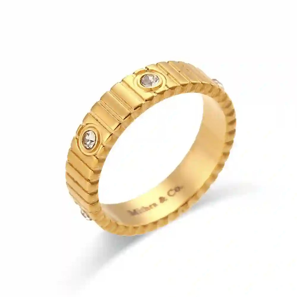 Studio shot of waterproof 18k Gold plated Coil Studded Ribbed Band Ring with Flush-Set Round Zircons. Shop at Mithra and Co.