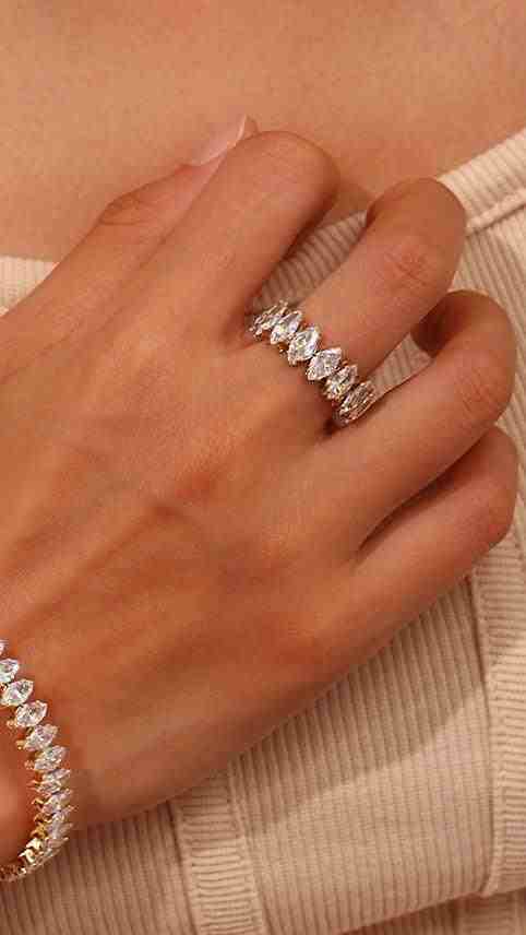 Closeup of a girl hand wearing victoria cuff bangle and Fifi ring Adjustable and flexible design with Open cut and Marquise set zircons.