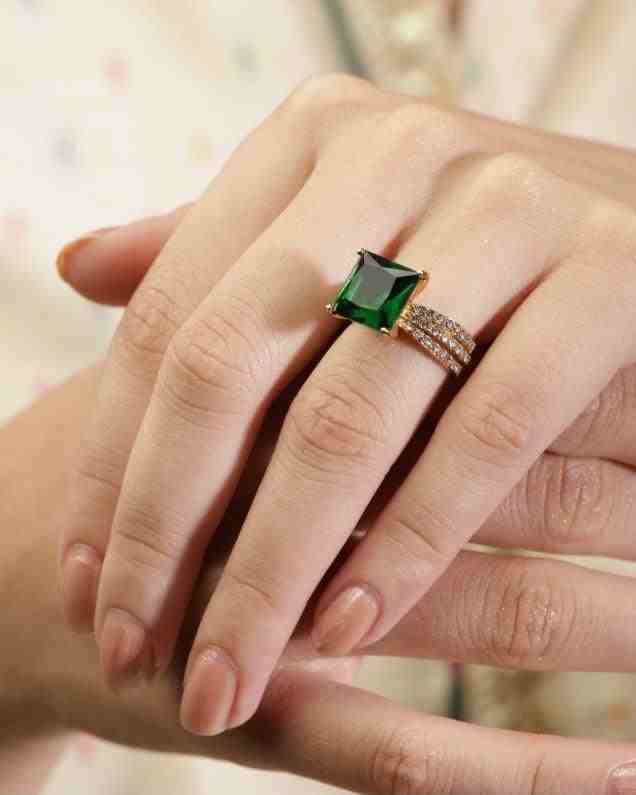GIrl wearing Gold Plated Emerald Square Stone Engagement Ring- Aura. Featuring dot shaped zircons on the band.