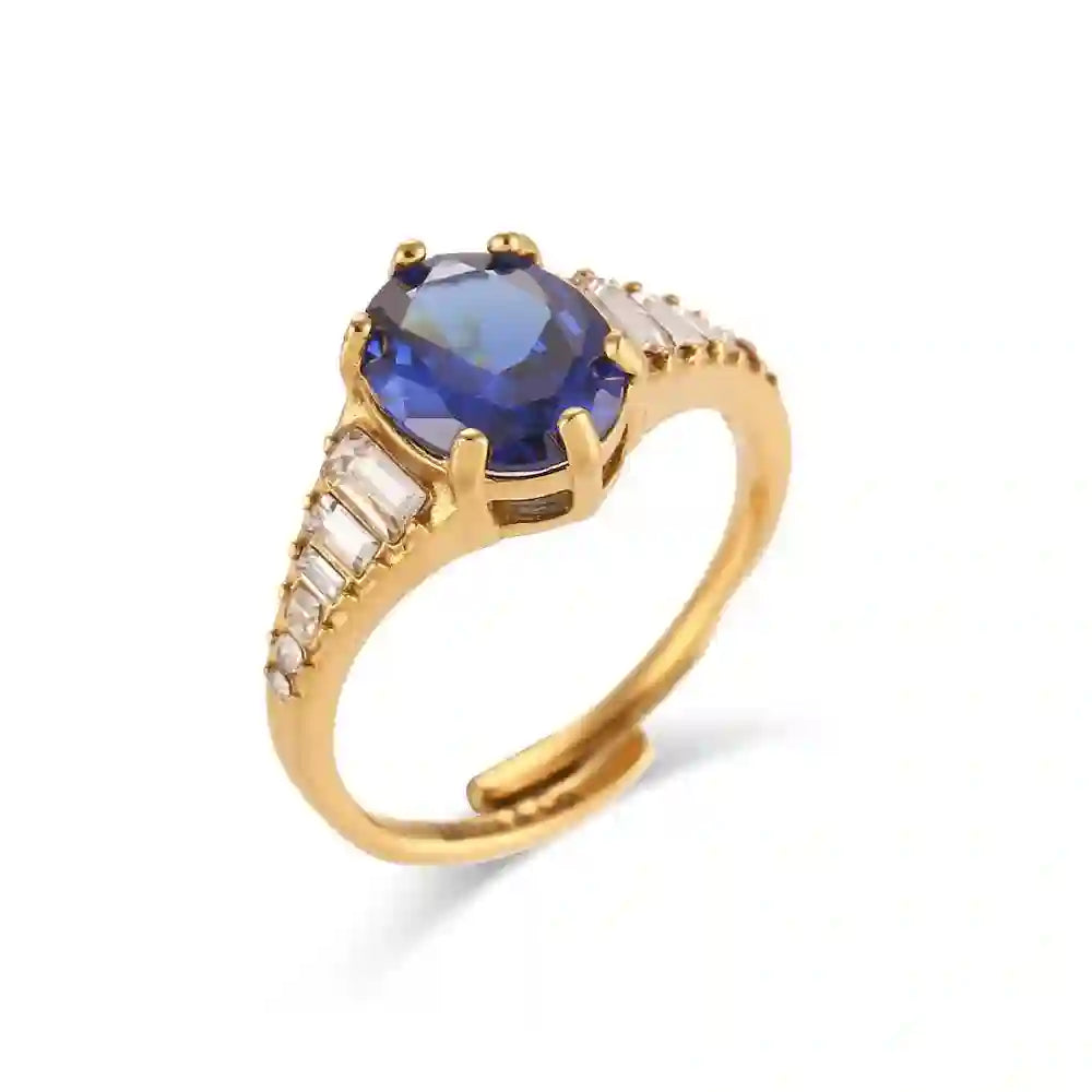 Studio shot of Zepher Sapphire Ring. Oval-cut Blue Sapphire Gold Statement Ring with Baguette Zircons with wite Bg.