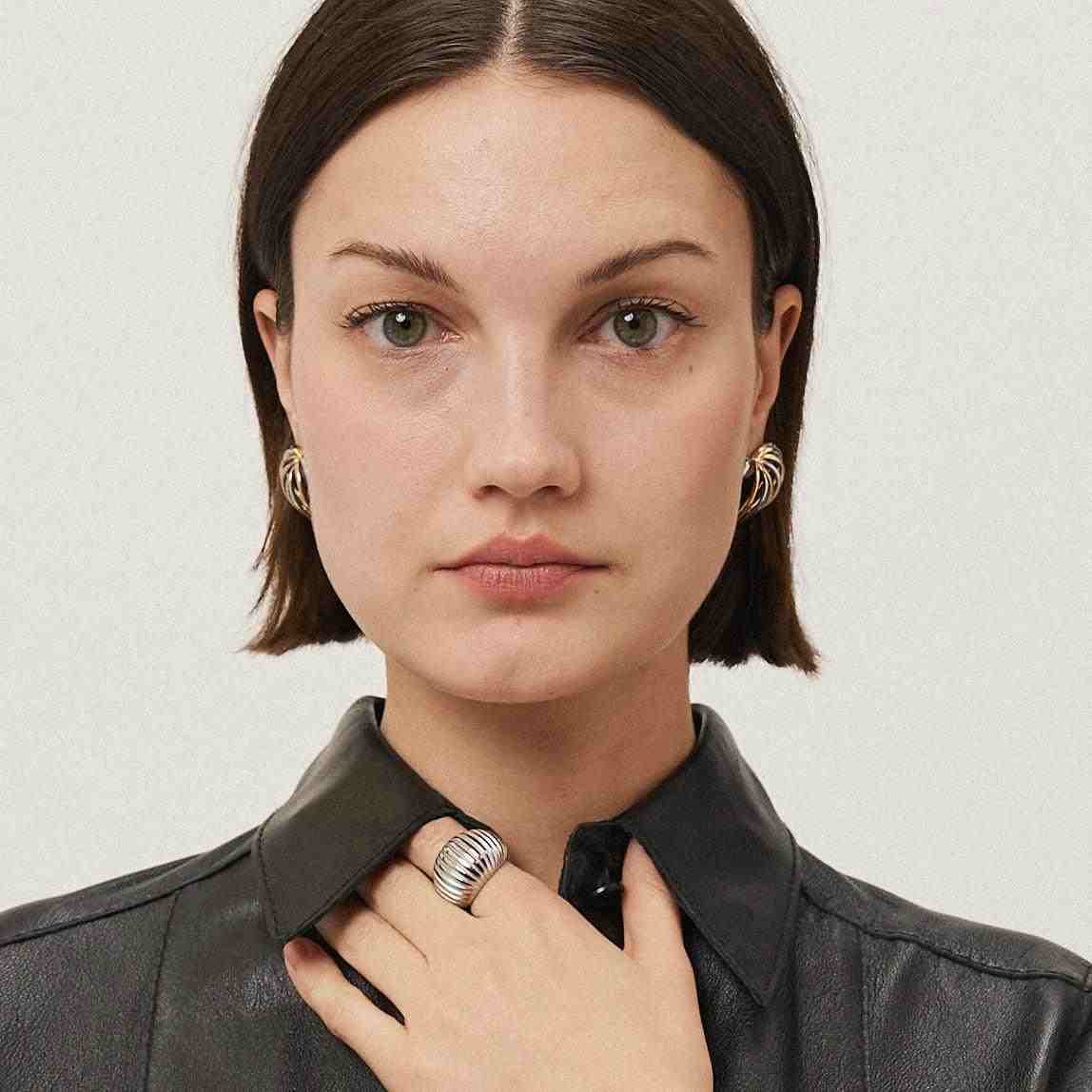 Girl wearing silver plated ring.