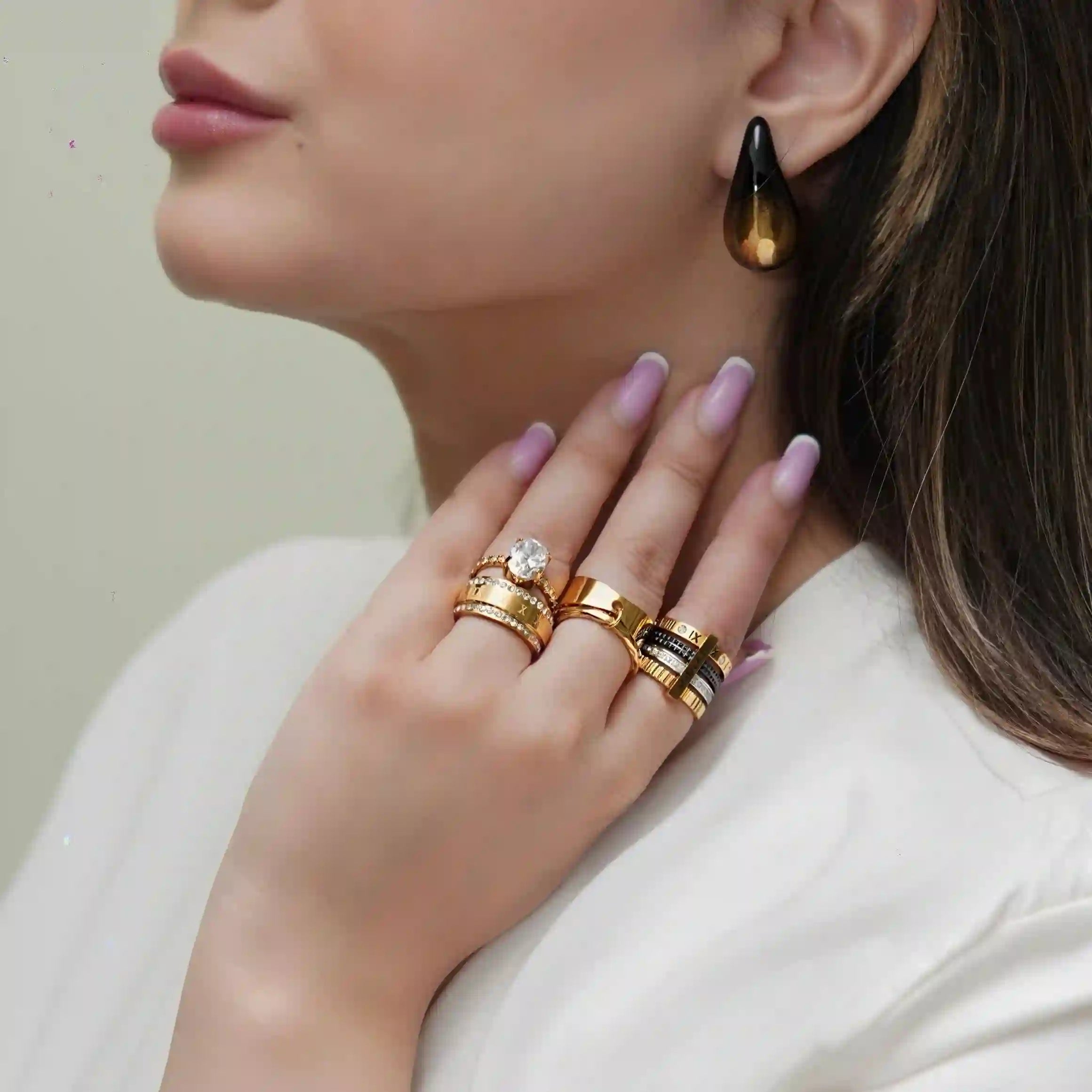 Girl wearing gold plated rings and studs. Shop at Mithra and Co.