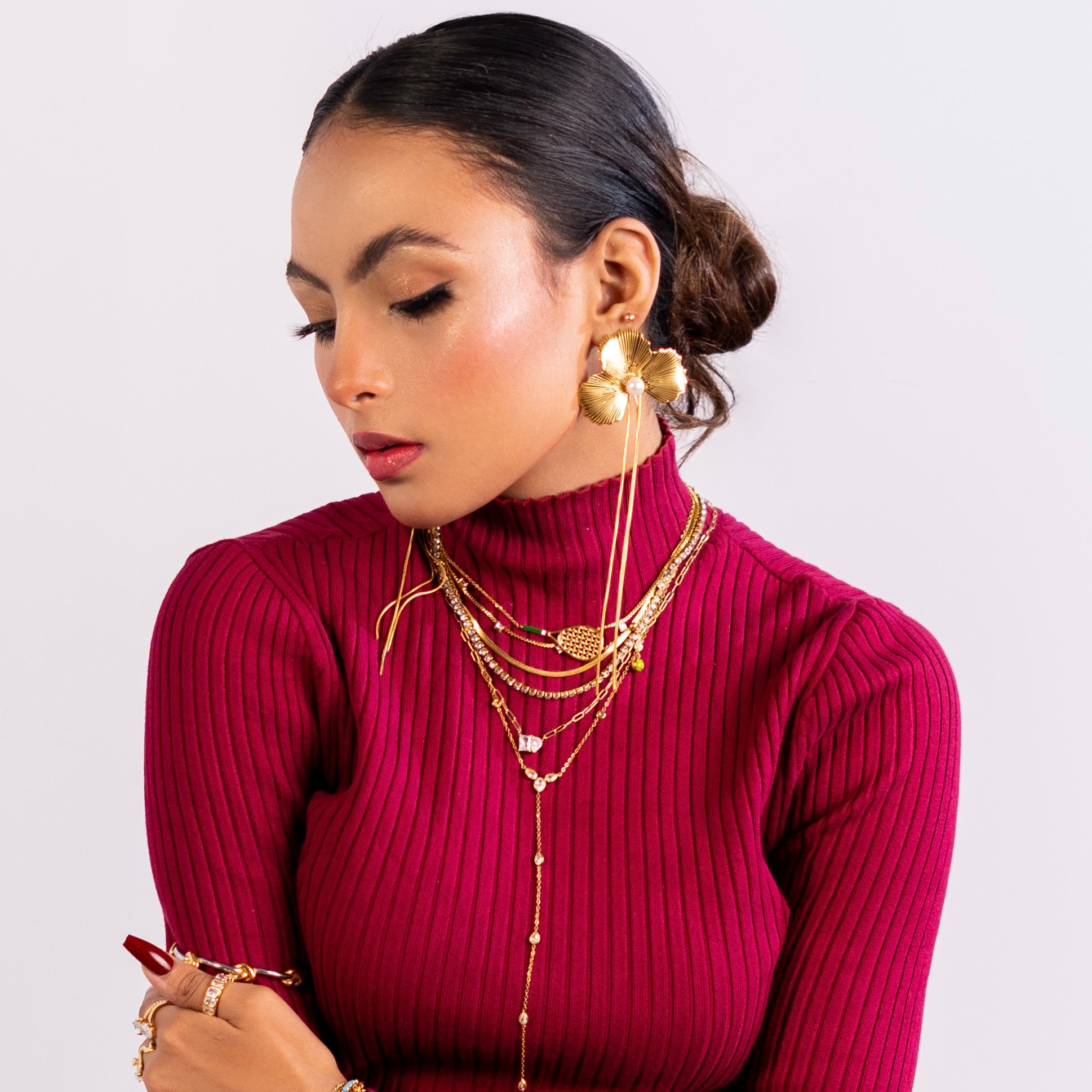 Girl Wearing Red top and Firma Lilly Studs, gold Plated necklaces, neck chains and rings.