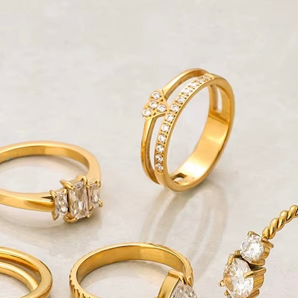 Tarnish free Gold plated rings with diamond accents on a light gray background.