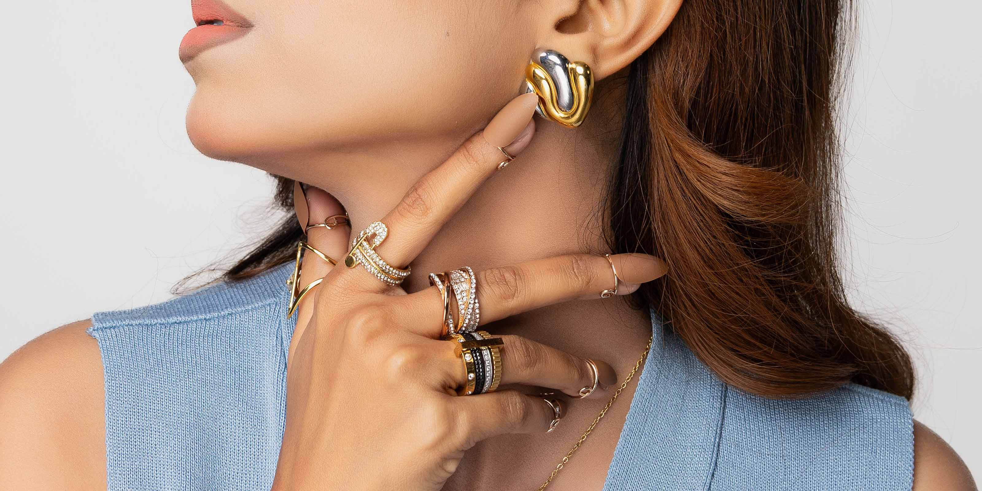 Close up of a Girl wearing 18k gp rings and Earring. Shop at Mithra and Co Official Pakistan.