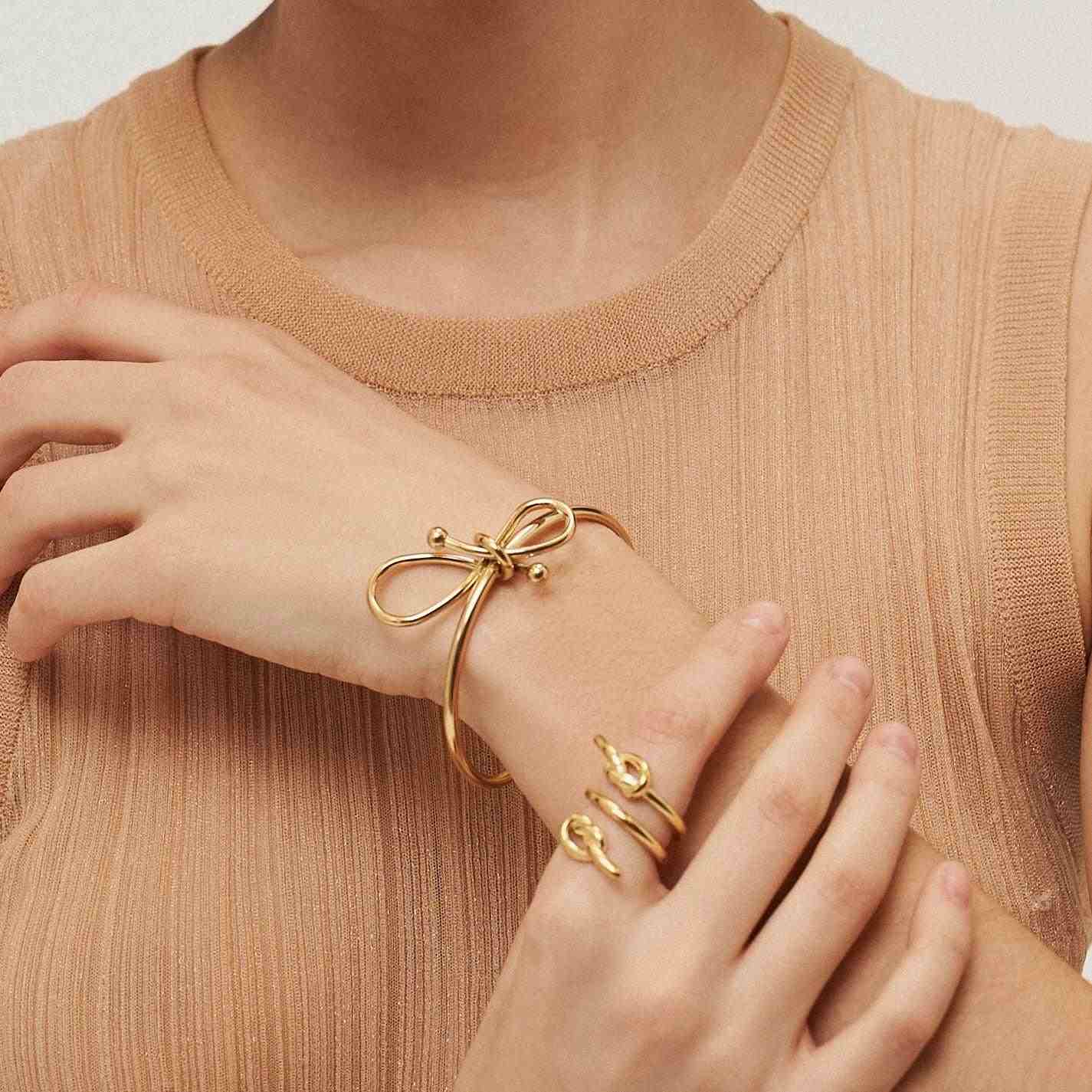 Girl Wearing 18k gold plated Ring and Cuff. Buy Now at Mithra and Co.