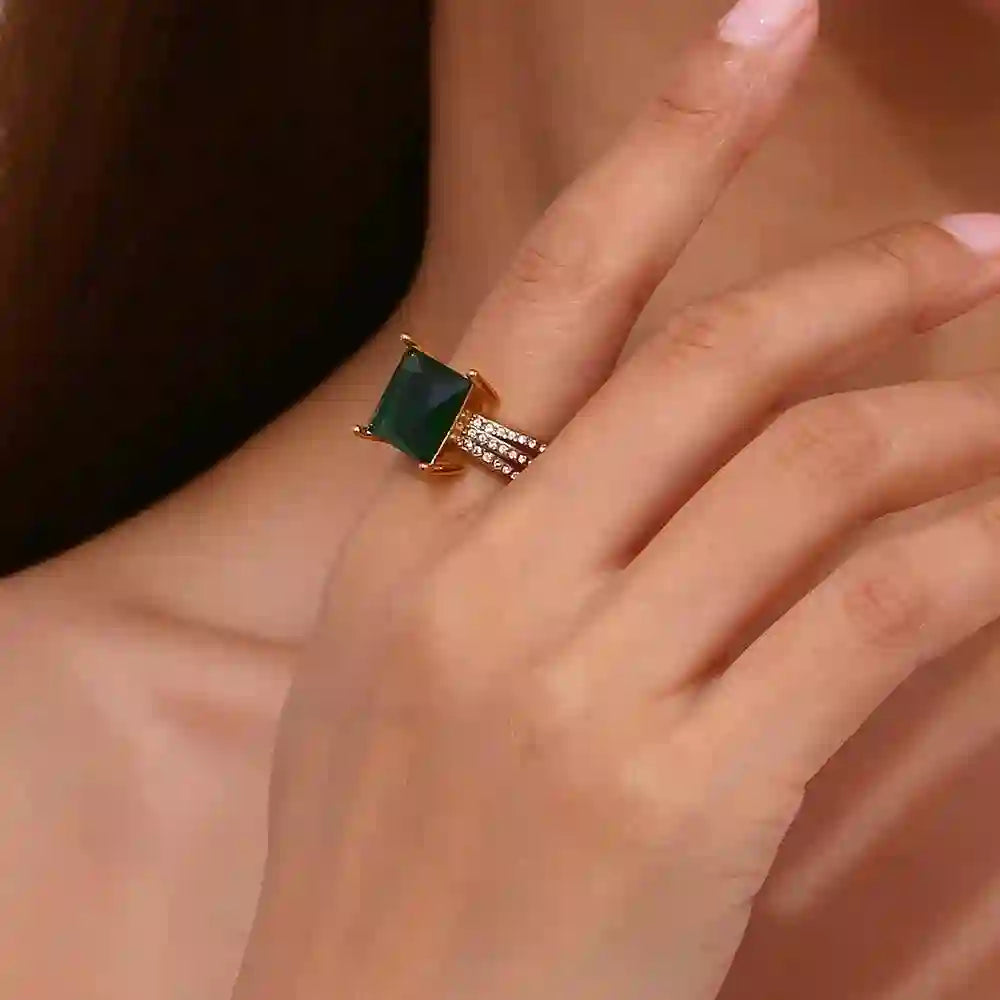 Closeup of a hand wearing Aura ring with Square Emerald Green Gemstone in Index finger.