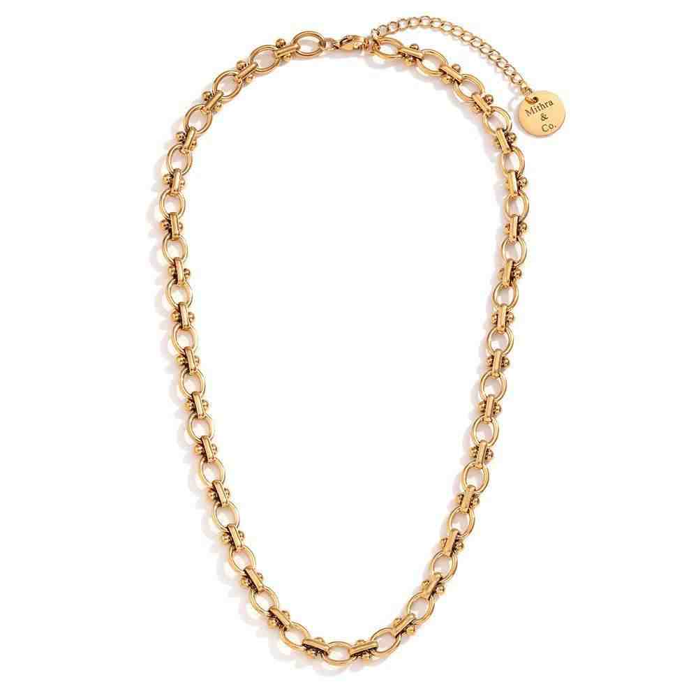 Studio shot of Delulu chain necklace.  Featuring Beaded Station Oval Link Architecture on 18k Gold plated steel.