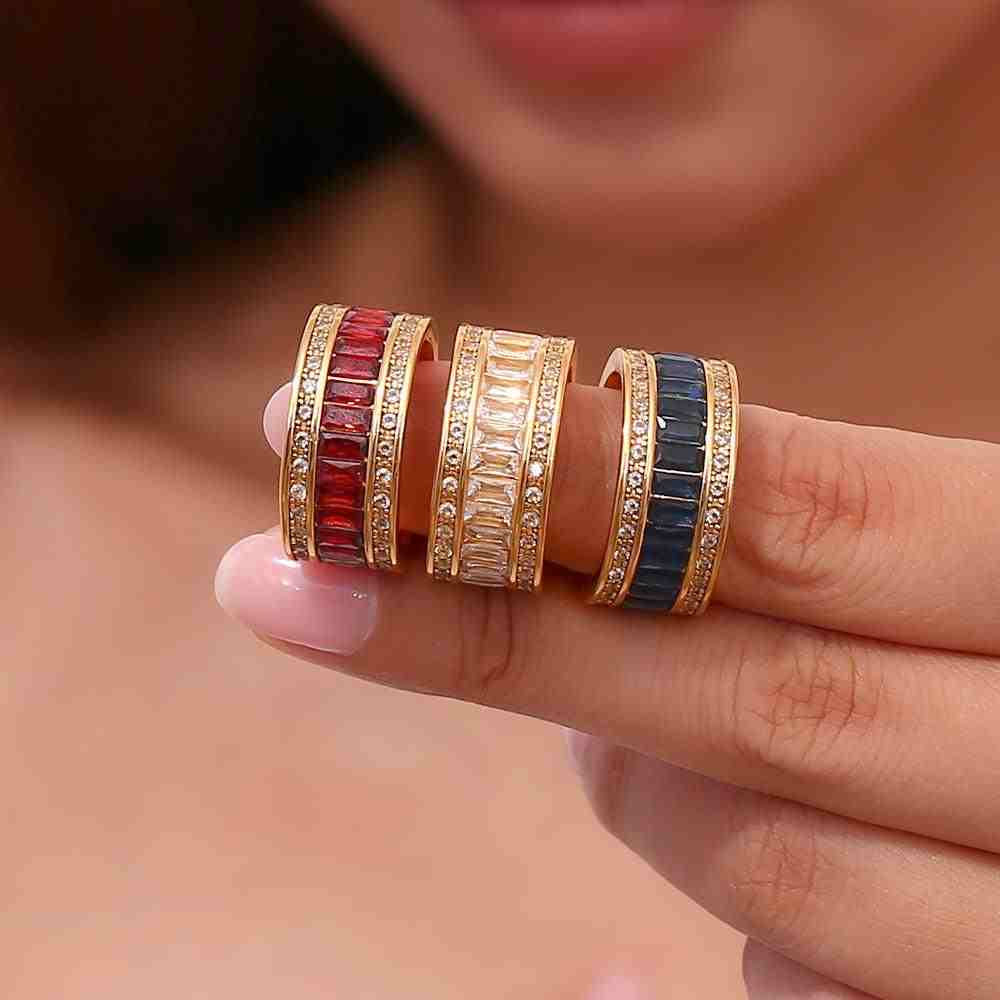 GIrl Wearing 18k gold plated eclipse band rings burnt red sapphire and white zircon. Shop Online in Pakistan.