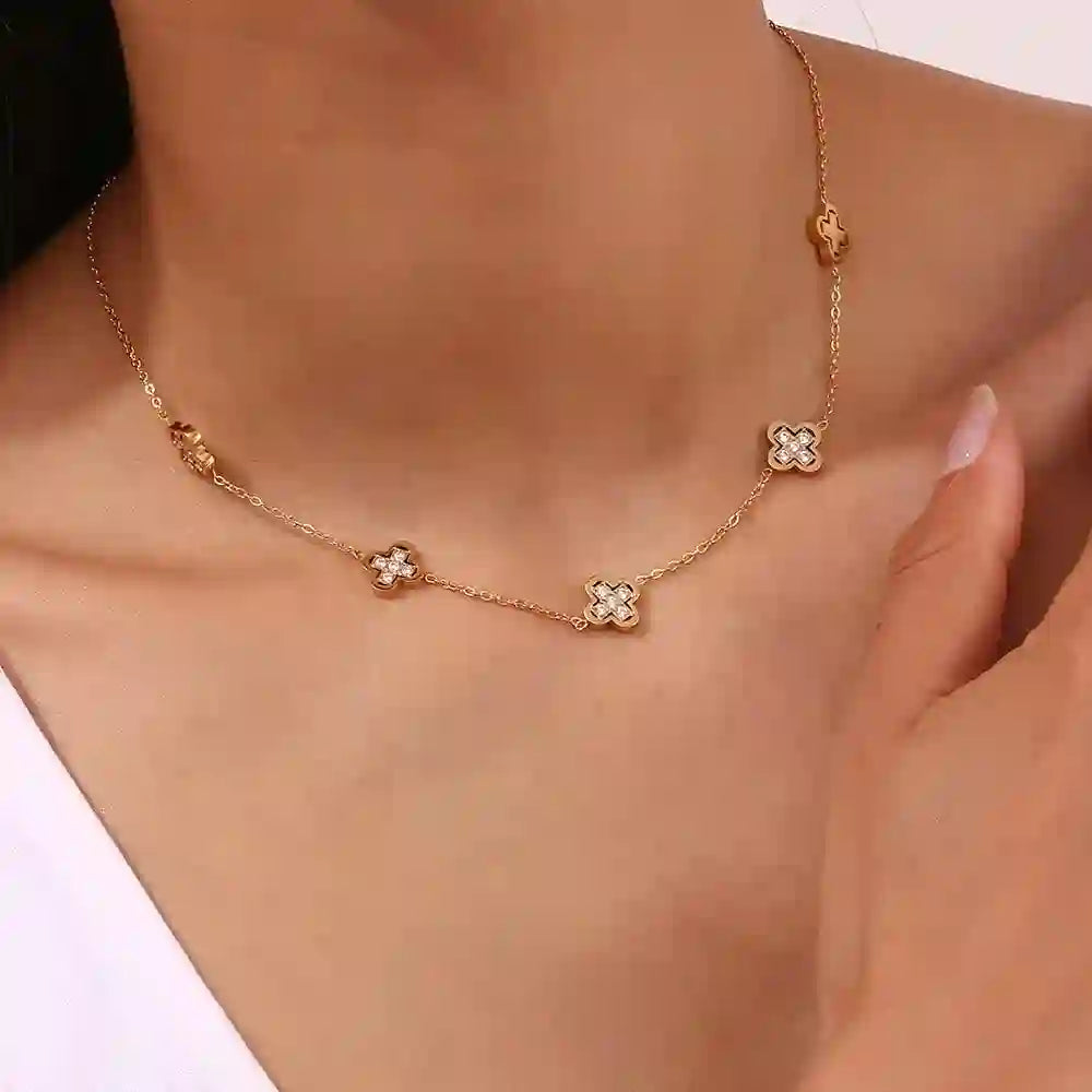 Closeup of a Girl wearing 18k Gold Plated Gilded 5-Clover-Motif Zircon-Inlaid Chain Necklace. Shop at Mithra and Co.