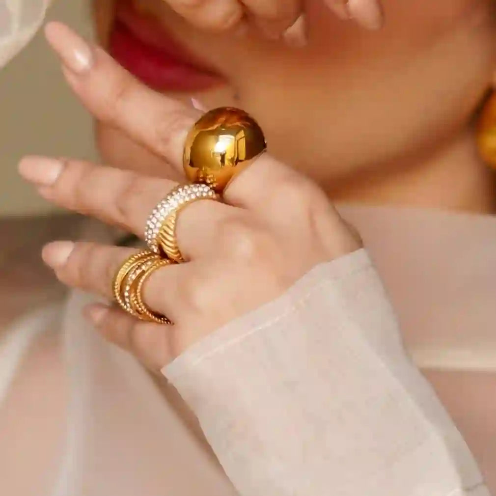 Girl wearing Stacking ring Crossover ring with Orb ring that features a Spherical Gold Plated Dome Design.