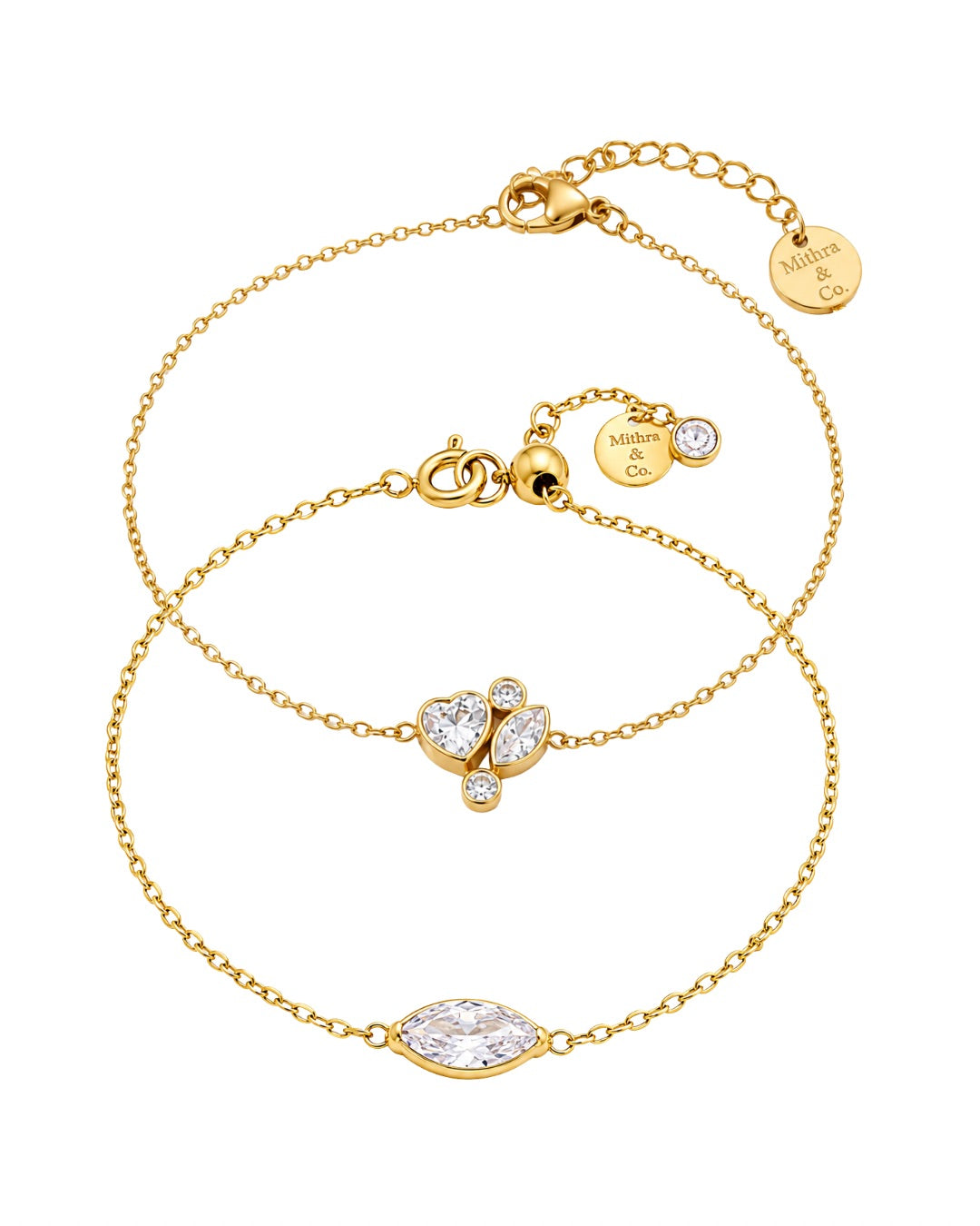 Petal Duo Bracelet Set Contains 2 gold chain bracelets with heart-shaped and marquise-shaped clear crystal settings, displayed on a clean white background. Each bracelet features a lobster clasp and a small round branded tag engraved with 'MITHRA AND CO'.