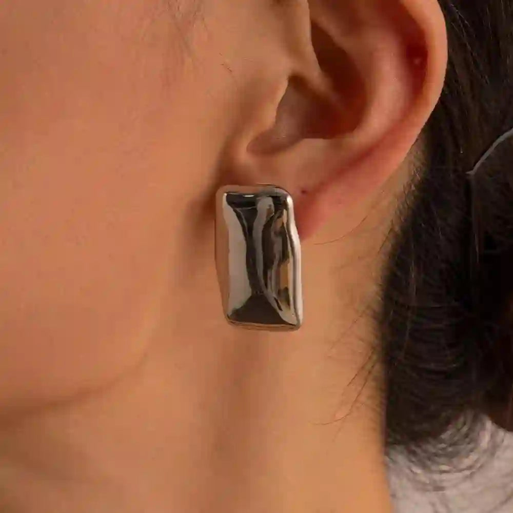 Closeup of Girl left ear wearing Silver Plated Rectangle Shaped Earrings - Pharaoh SIlver with an Asymmetric Soft-Edge Rectangular Stud Architecture.