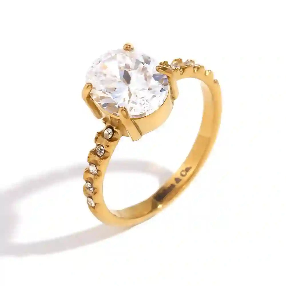 Studio shot of Regal Opulence ring. 18k gold plated circular solitaire stone and Micro-Pavé CZ Shanks with Mithra & Co. Engraveed inside.