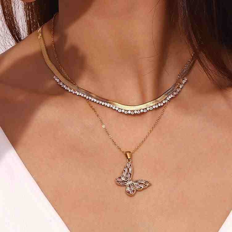 Girl wearing 18k Gold Plated Enchanted Flutter Necklace with Serenade Gold Necklace. Asymmetric Herringbone Chain with Zircon Edge. 