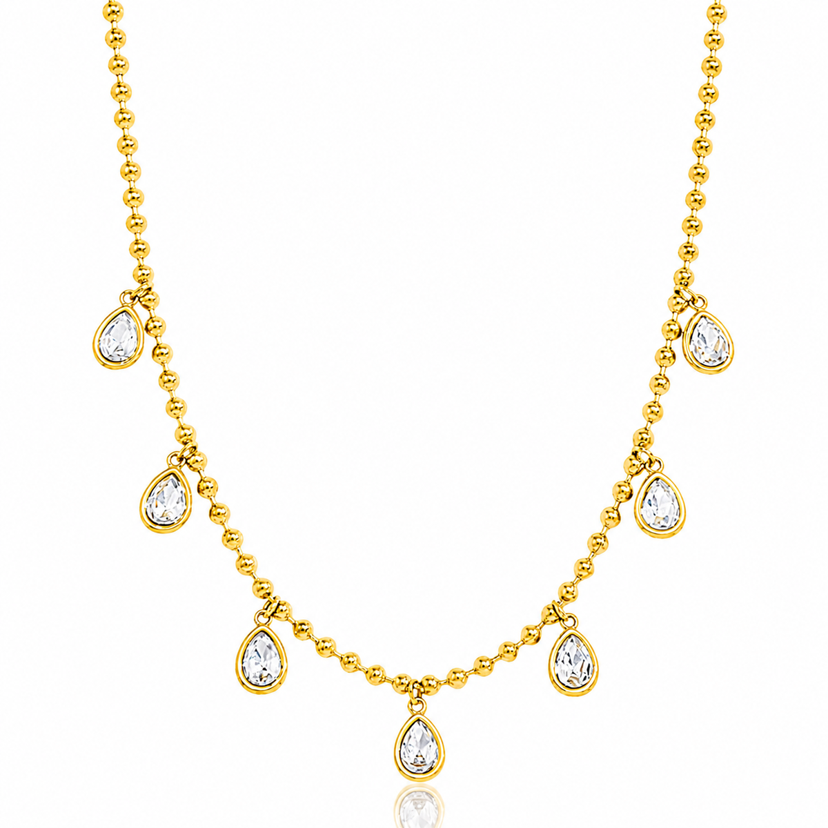 A gold beaded necklace featuring seven teardrop-shaped clear gemstones set in gold at intervals, displayed on a clean white background.