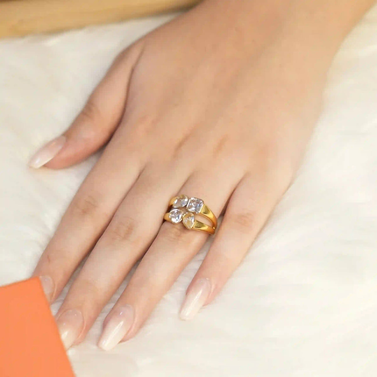 Closeup of girl wearing Gold Plated 4 stone mixed cut tetra ring. Shop Online at Mithra and Co.