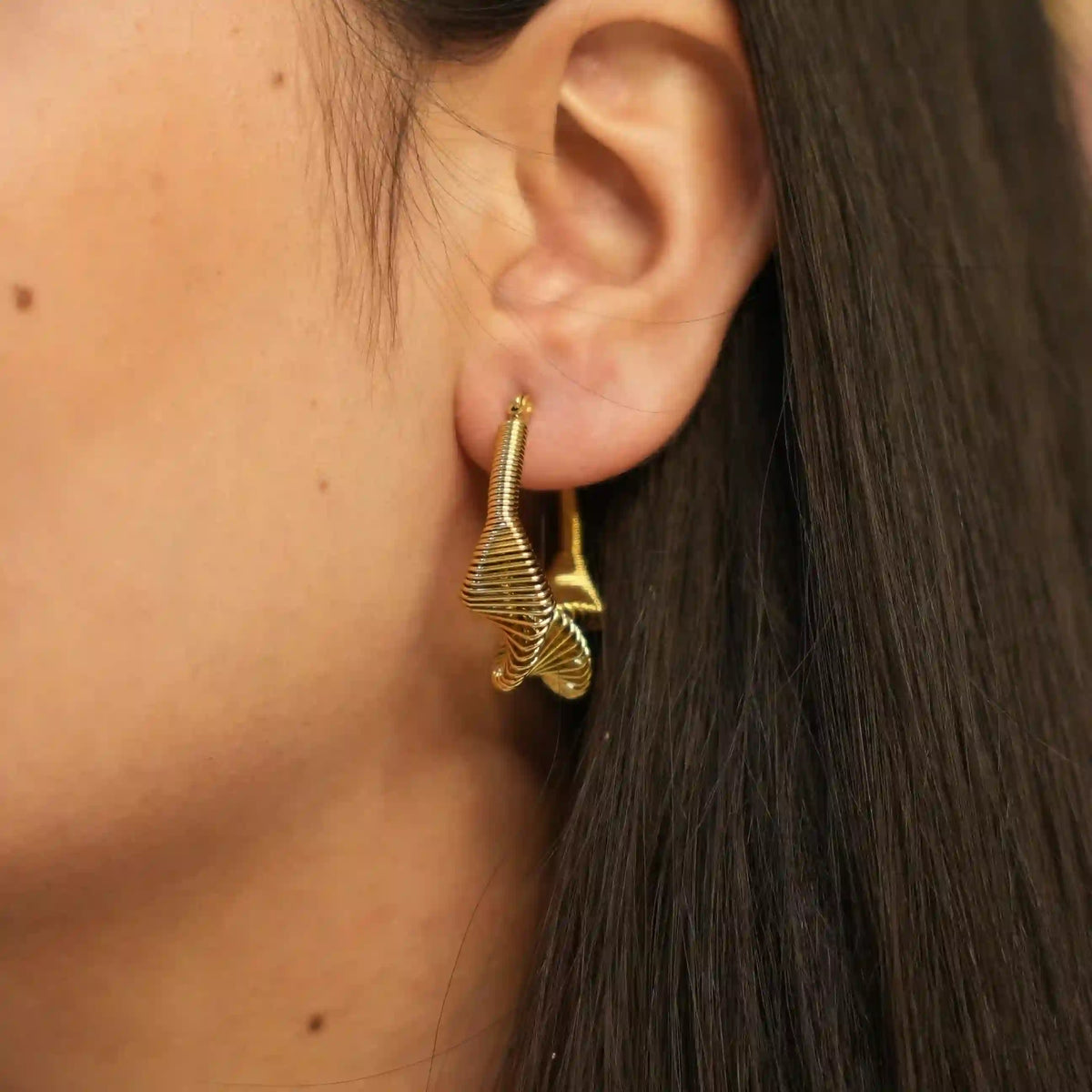 Girl wearing 18k gold Plated Sculptural Wire Mesh Spring Hoop Earrings - Vela. Shop Online at Mithra and Co.