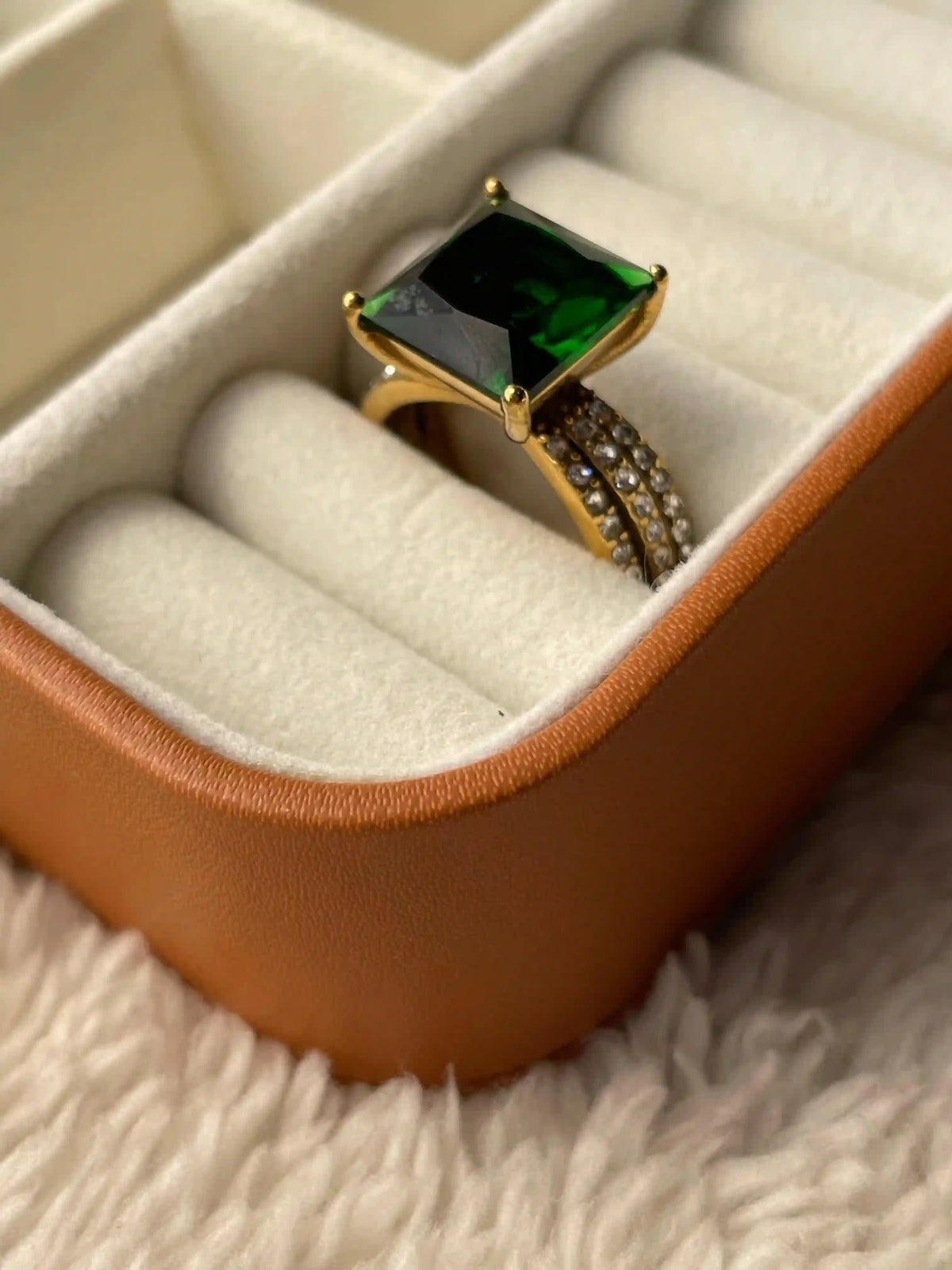 Jewelry Box Showcasing Aura Ring with Square Shaed Emerald Green Stone. Dot shaped zircons on 18k gold plated band.