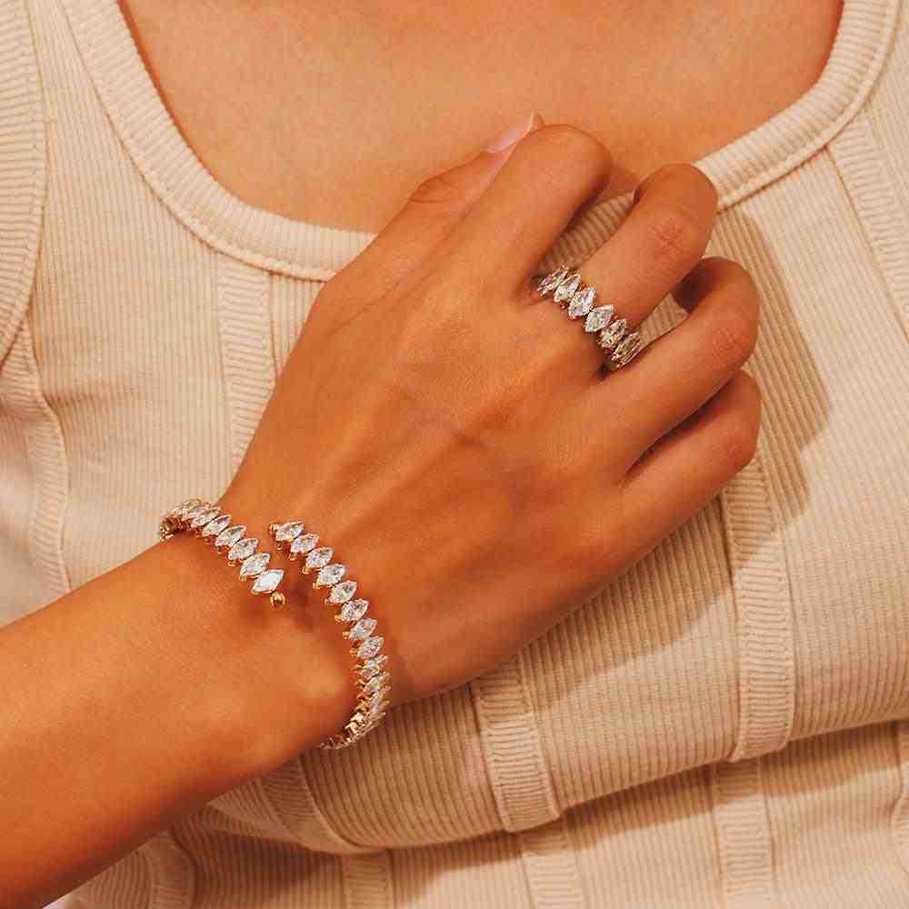 Girl wearing Fifi ring and victoria cuff bangle with a white top in bg. Adjustable Flexible open cut design with Marquise cut Zircons.
