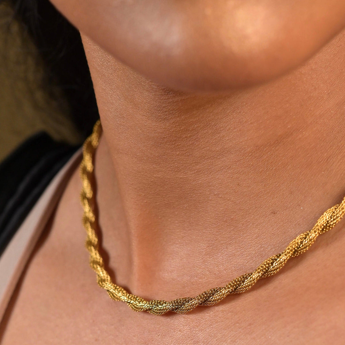 Closeup of a woman neck wearing Harper twisted rope chain neckalce. Buy online at Mithra and Co..
