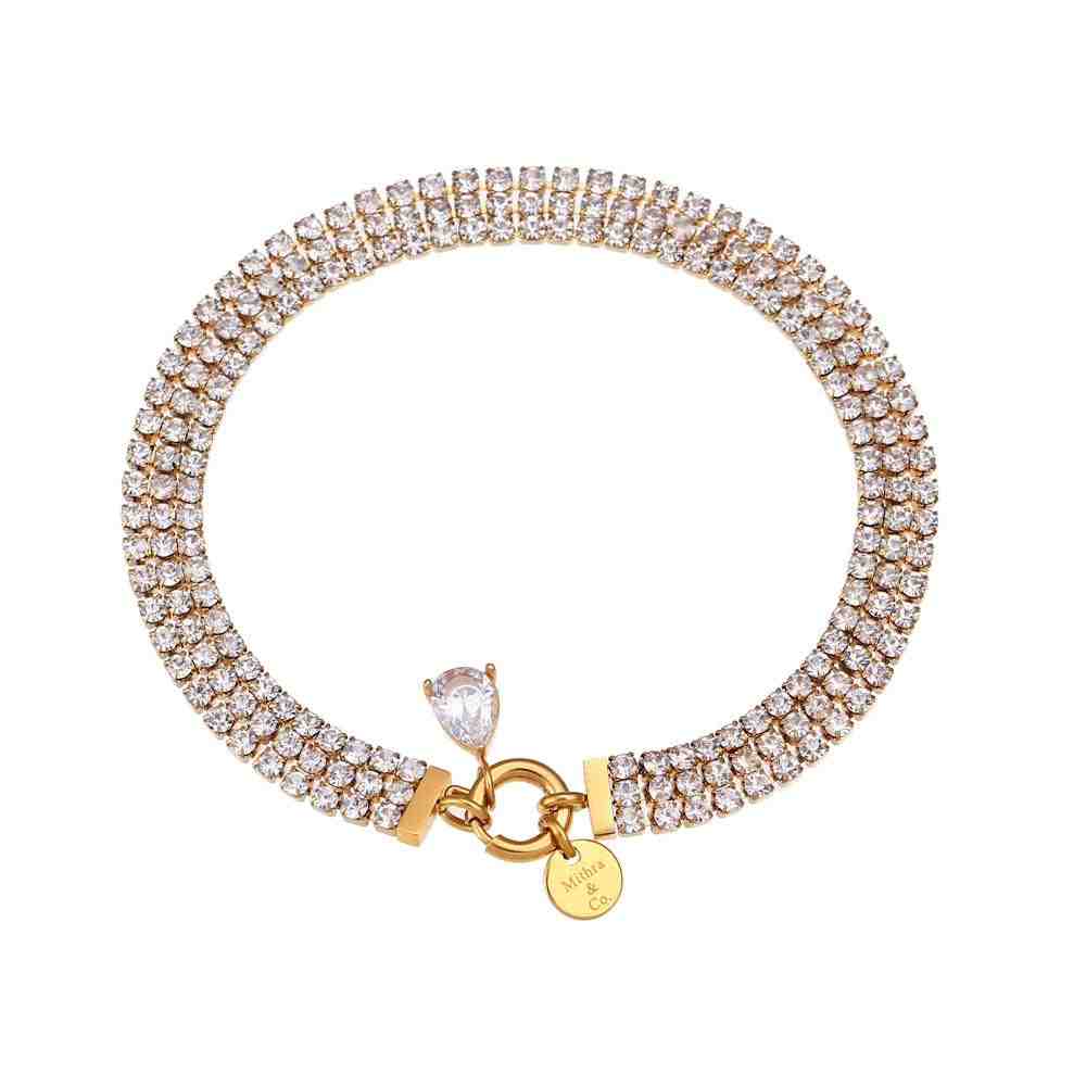 Studio shot of Kendall diamontee bracelet featuring Triple-Tier Pavé Crystal Architecture with clear stones and a charm on a white background