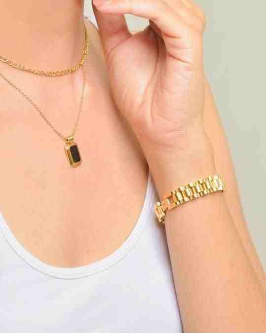 woman wearing 18k Gold Plated pendant necklace and matching bold watchaband bracelet with white tank top