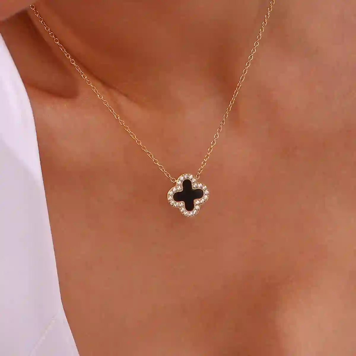 Black Clover Necklace 18k Gold plated with Zircons around with Onyx-Inlaid Floral Silhouette in center.