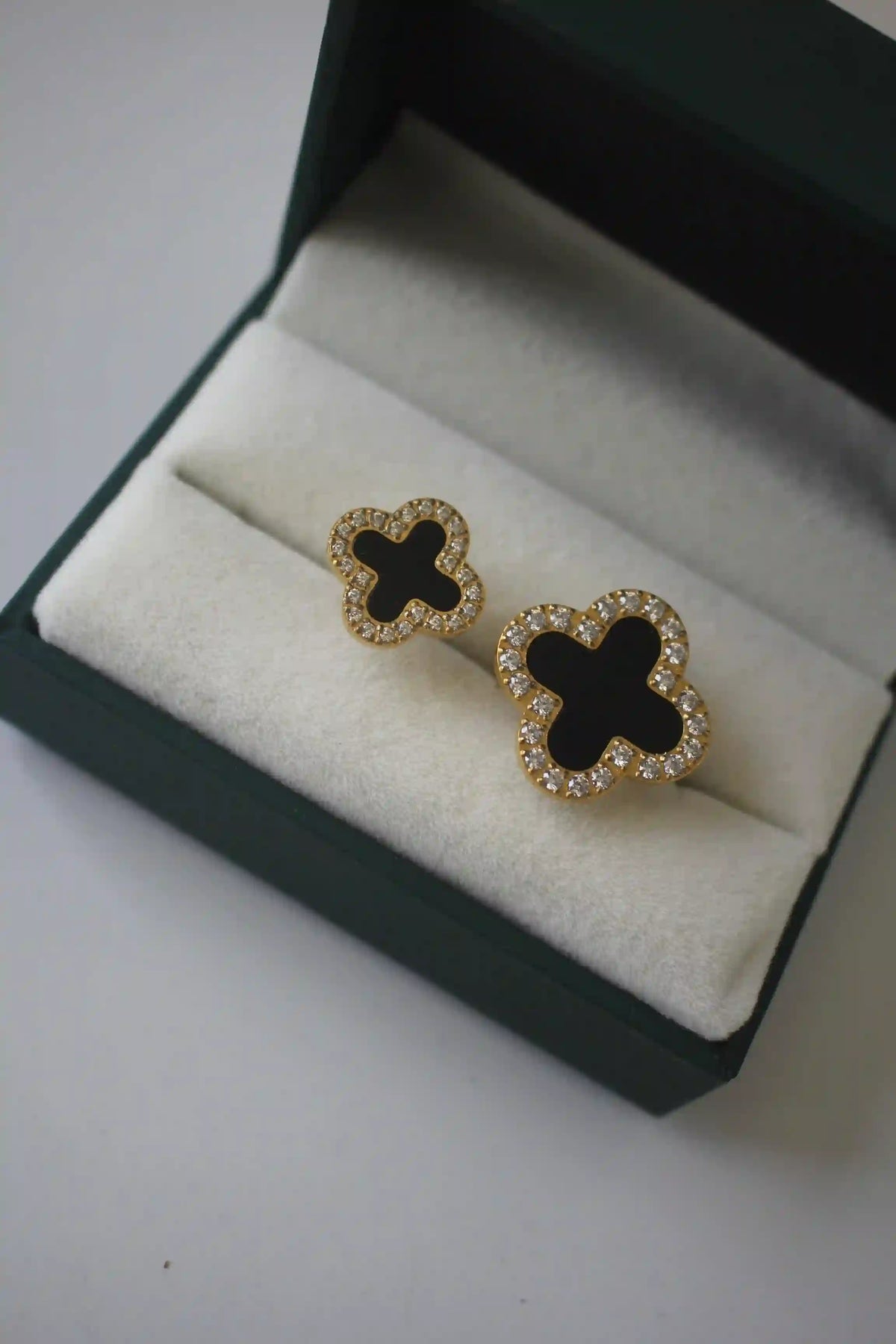 Closeup of Midnight clover flower ring in Blue box display. Featuring Open Cut Adjustable Double Black Clover Motif Design with Pave Zircons.