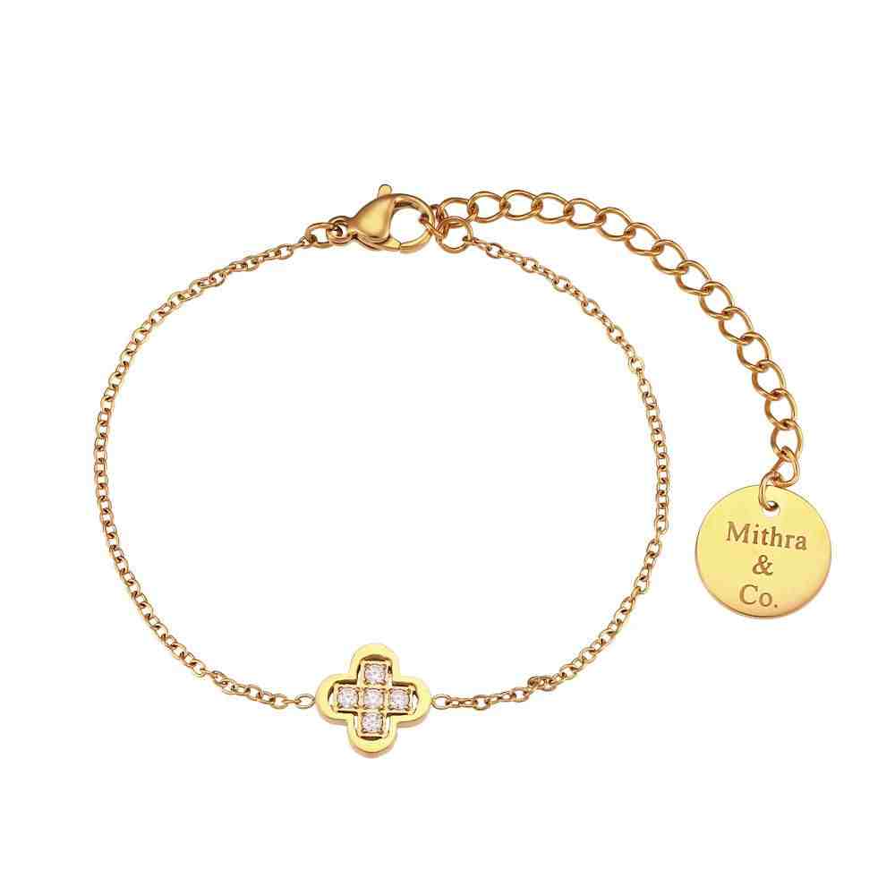 Studio shot of Petit Clover Bracelet Solid Fill Multi Zircon Stone Blossom Design with a Mithra & Co. Engraved Tag.