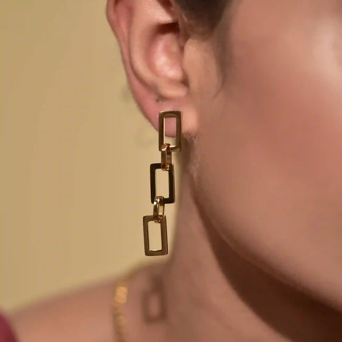 Closeup of a womans  left ear wearring Brooklyn Earrings | Rectangular Link Architectural Drop Design studs.  Shop Online at Mithra and Co Official.